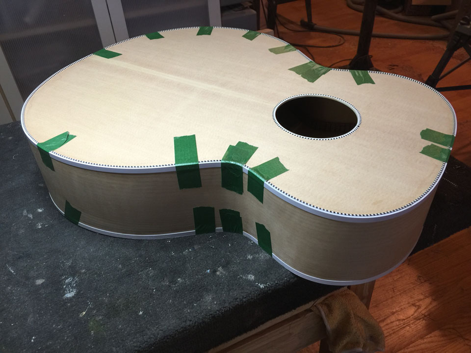 WHITE BINDING BEING GLUED TO THE "BLUEBURST" SOUND SAMPLE 700C JUMBO BODY.