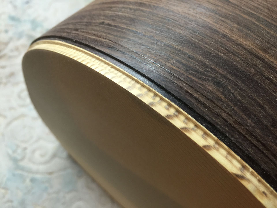 TOP AND SIDE OF A SPRUCE/ROSEWOOD 730S DREADNOUGHT, SHOWING THE DOUBLE-STEP ROUTING PROCESS.