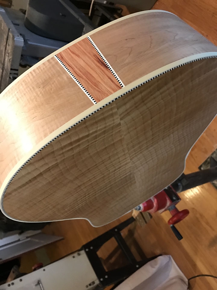 A TULIPWOOD "FLASH" WITH CHECKERBOARD AND WHITE BOUND EDGES, ON A MAPLE GUITAR.
