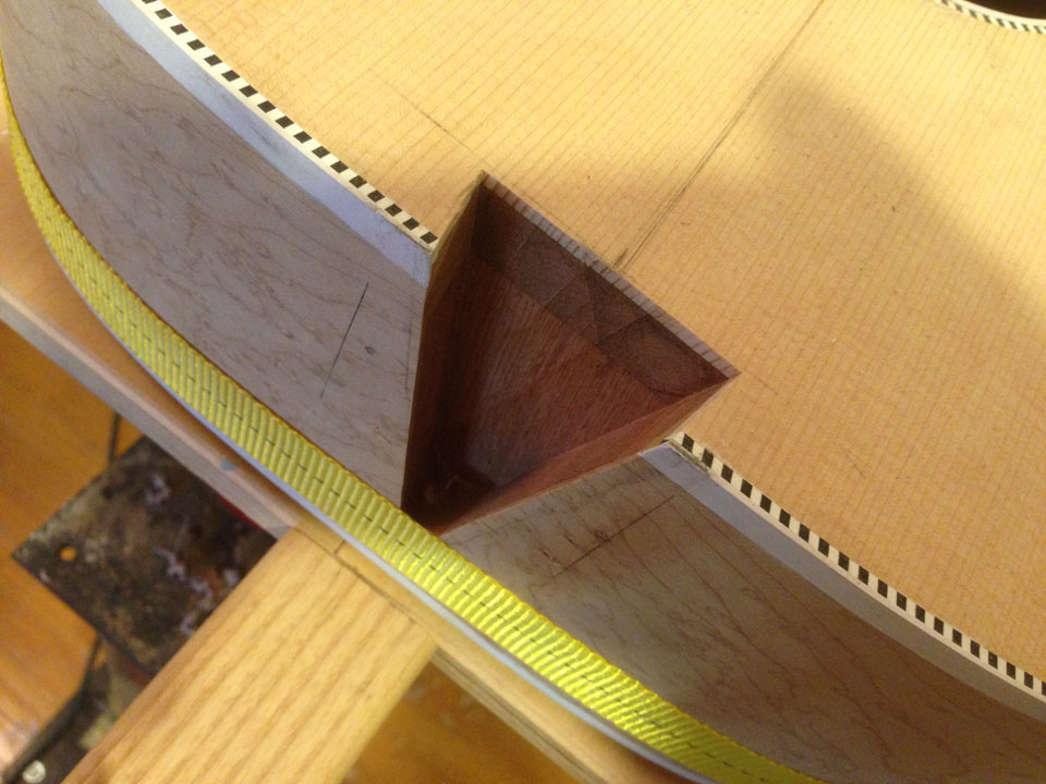THE NECK DOVETAIL IS CAREFULLY CUT WITH A ROUTER AND A SPECIAL TAPERED ROUTER BIT.