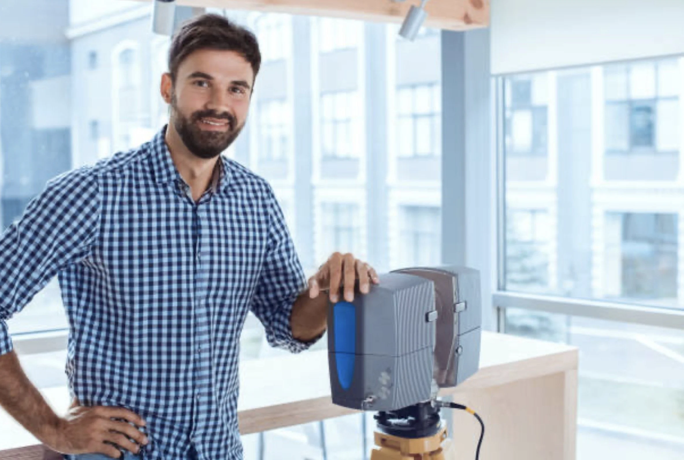 3D scanning technician with professional-grade LiDAR scanner preparing to capture building data on a commercial construction site