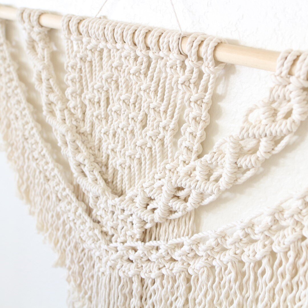 Did you see what's on the macrame calendar for July? It's a LARGE macrame wall hanging project 🤩⁠
⁠
Hanging from a 3-foot wood dowel, you will learn all the foundation knots of macrame and create this swooping beauty. You'll impress yourself, I prom