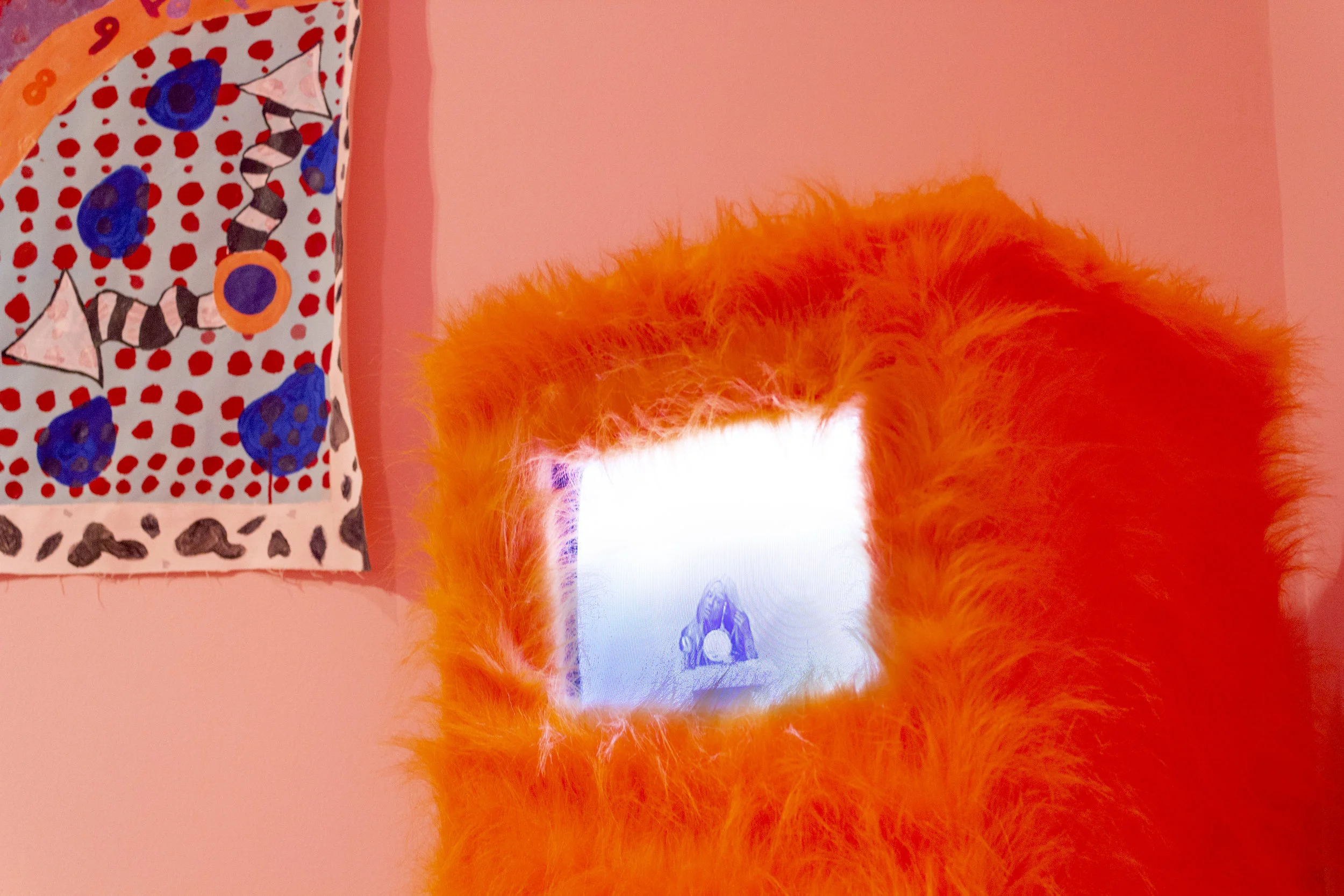 in my sleep i said dont touch my fur box, 2019, MDF wood, orange faux fur, monitor, 49 inches x 16 inches Girl, 2019, single channel video with audio, duration 3 minutes 37 seconds Exhibit documentation by Gabrielle Wellensiek part of the 2019 Bachelors of Fine Arts Thesis Exhibition at Cornish College of the Arts