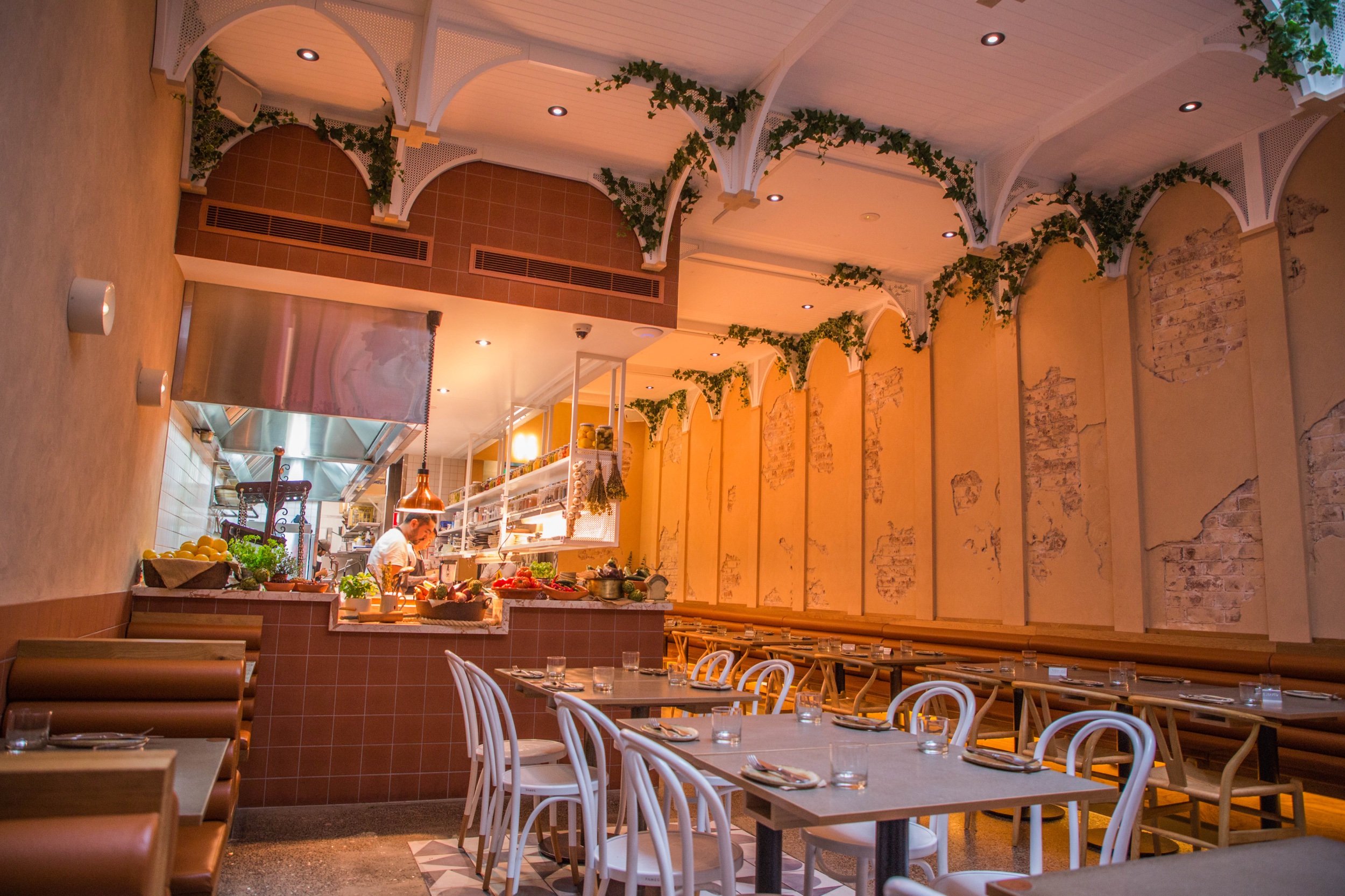  Restaurant floor with open kitchen and Middle Eastern decor 