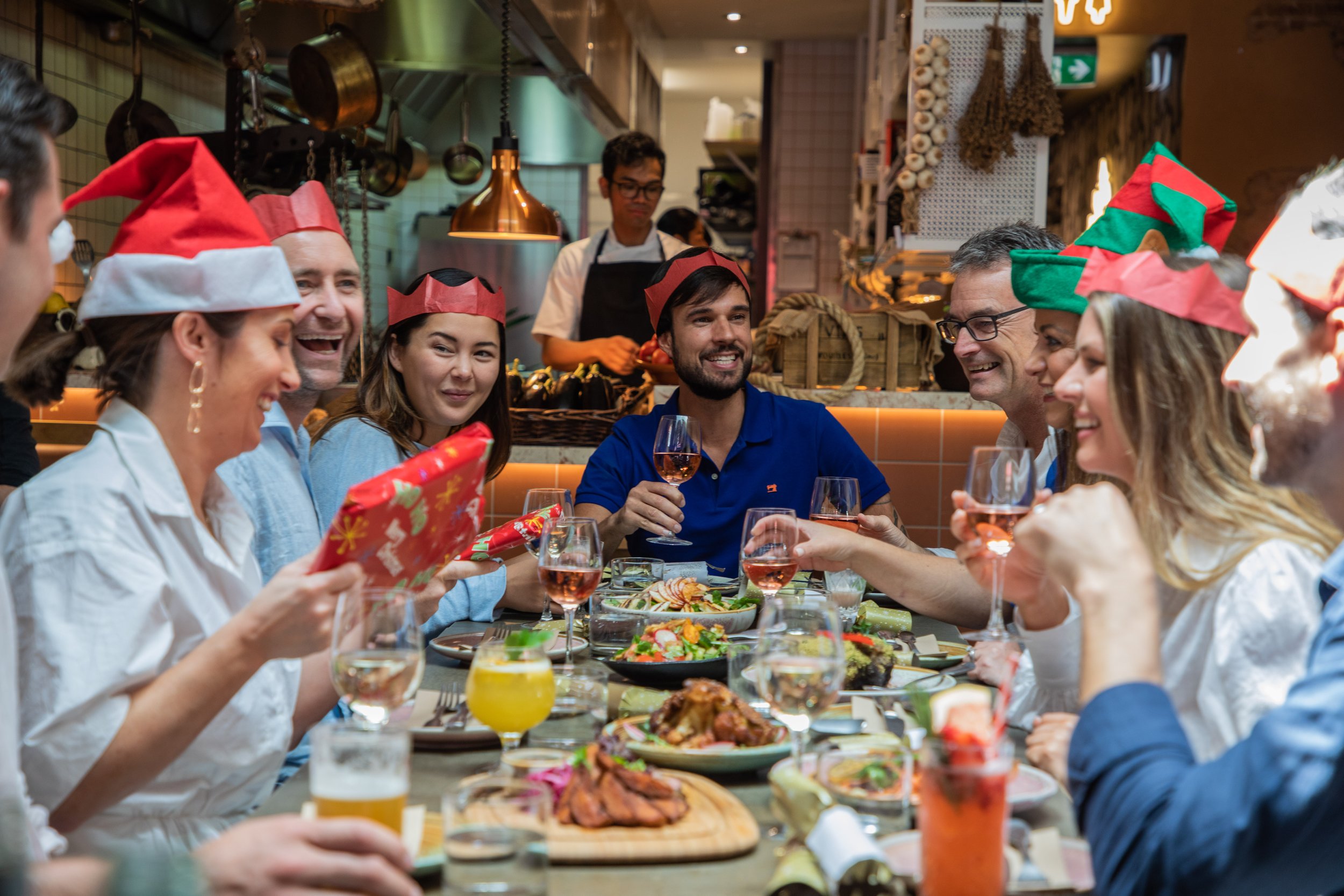  Friends sharing gifts at a Christmas Party at a Middle Eastern restaurant in Sydney. 