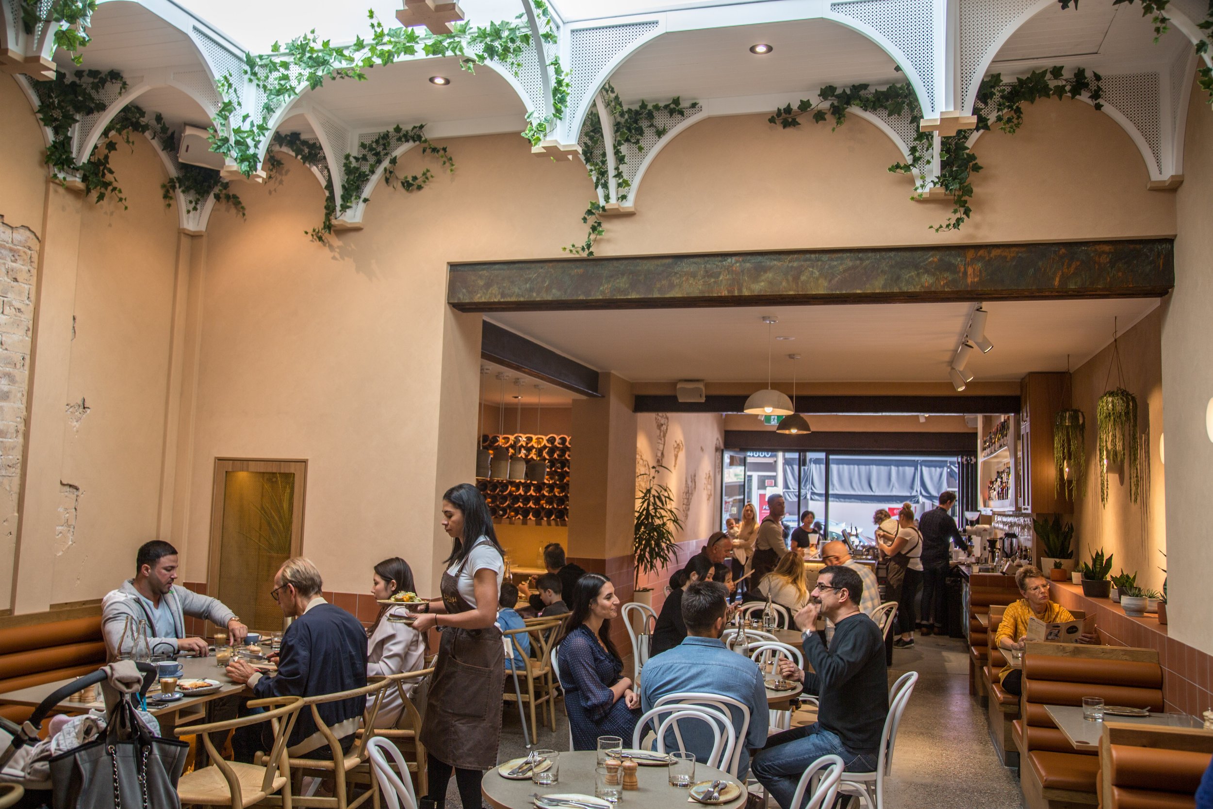  Cozy lunch in Sydney. Middle Eastern restaurant floor with lots of people seating at tables having a good time. Best lebanese restaurant sydney   