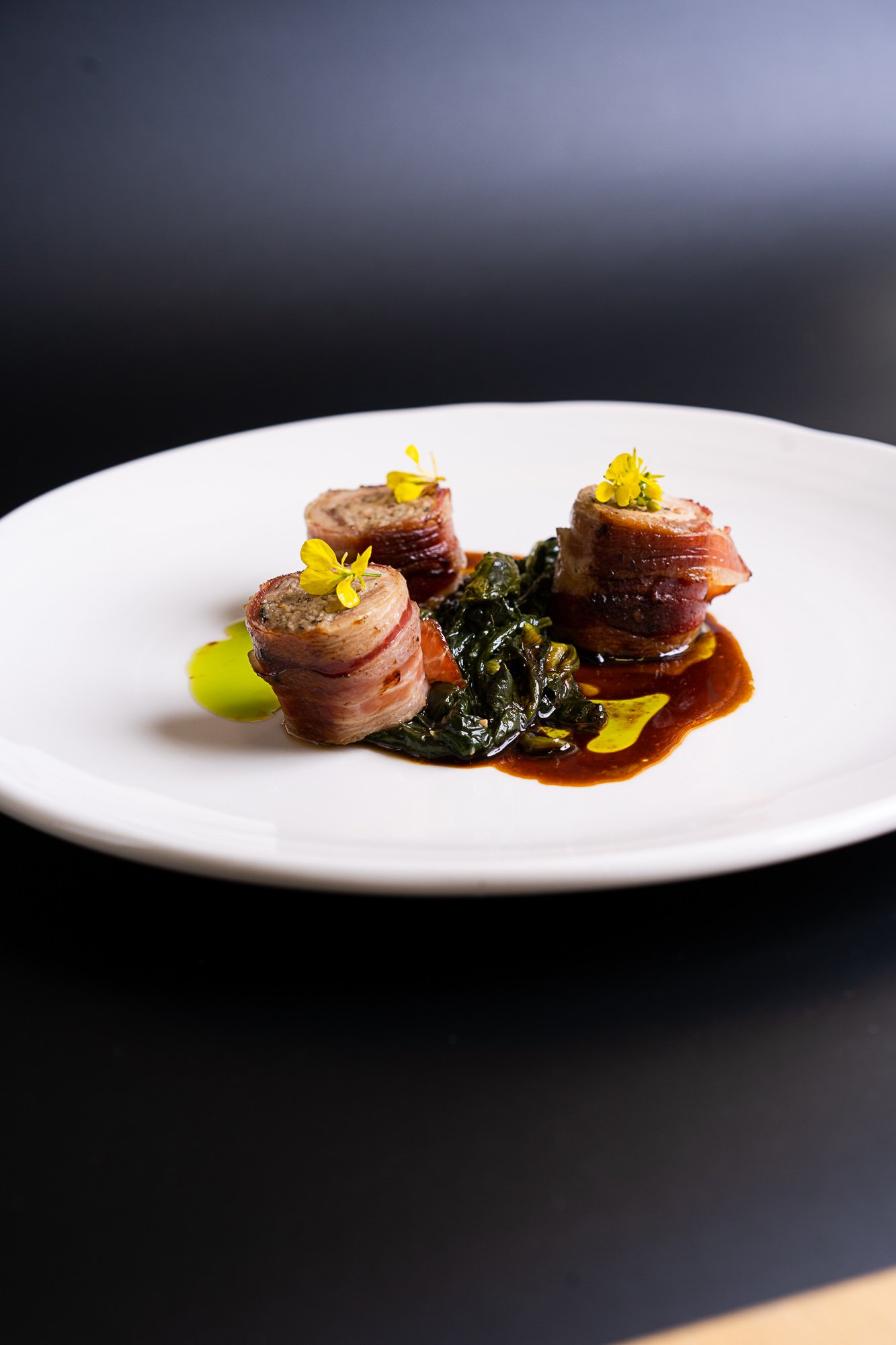 Stuffed quail with braised spinach pine nuts, raisins and jus.jpg