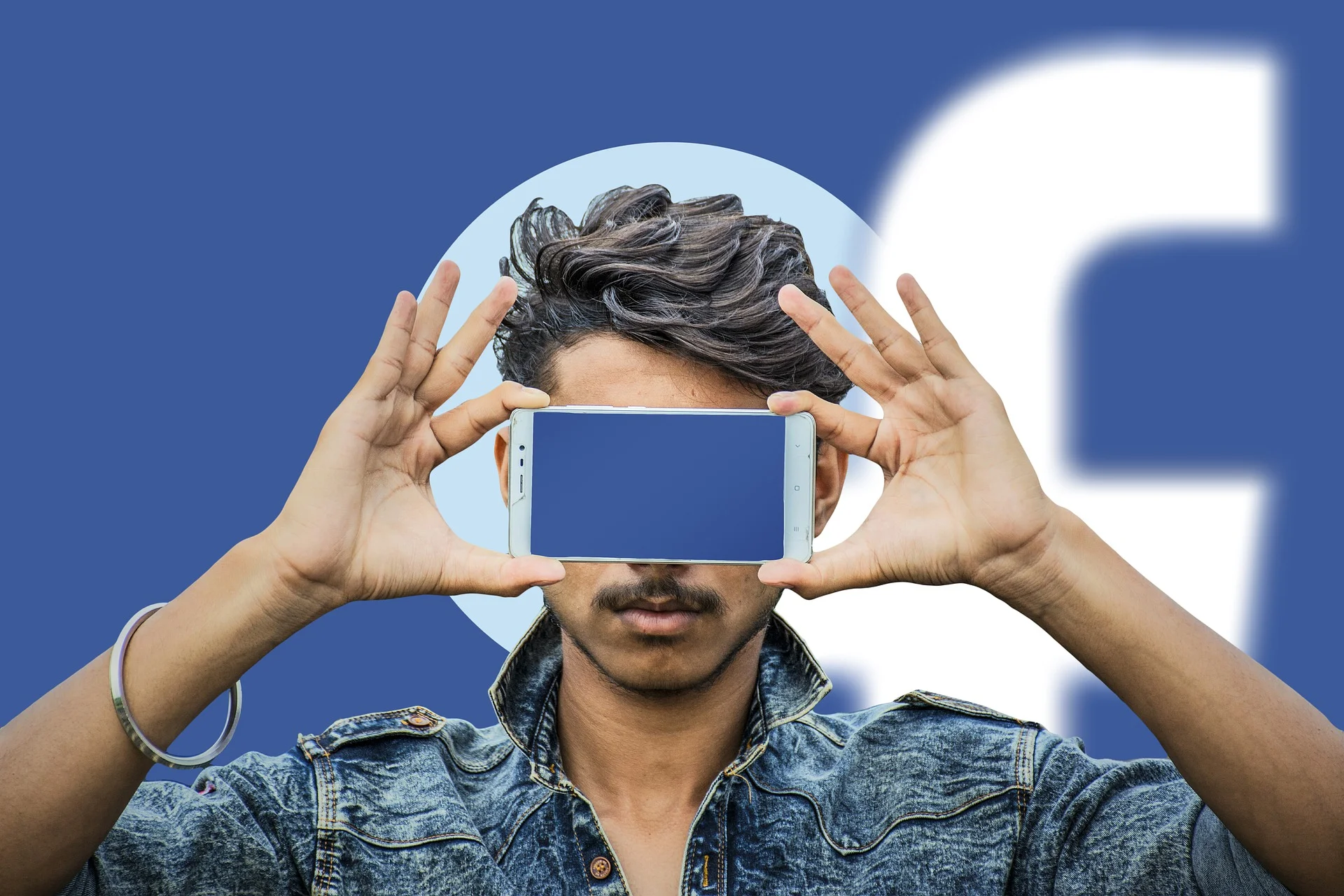 man holding smartphone over his face
