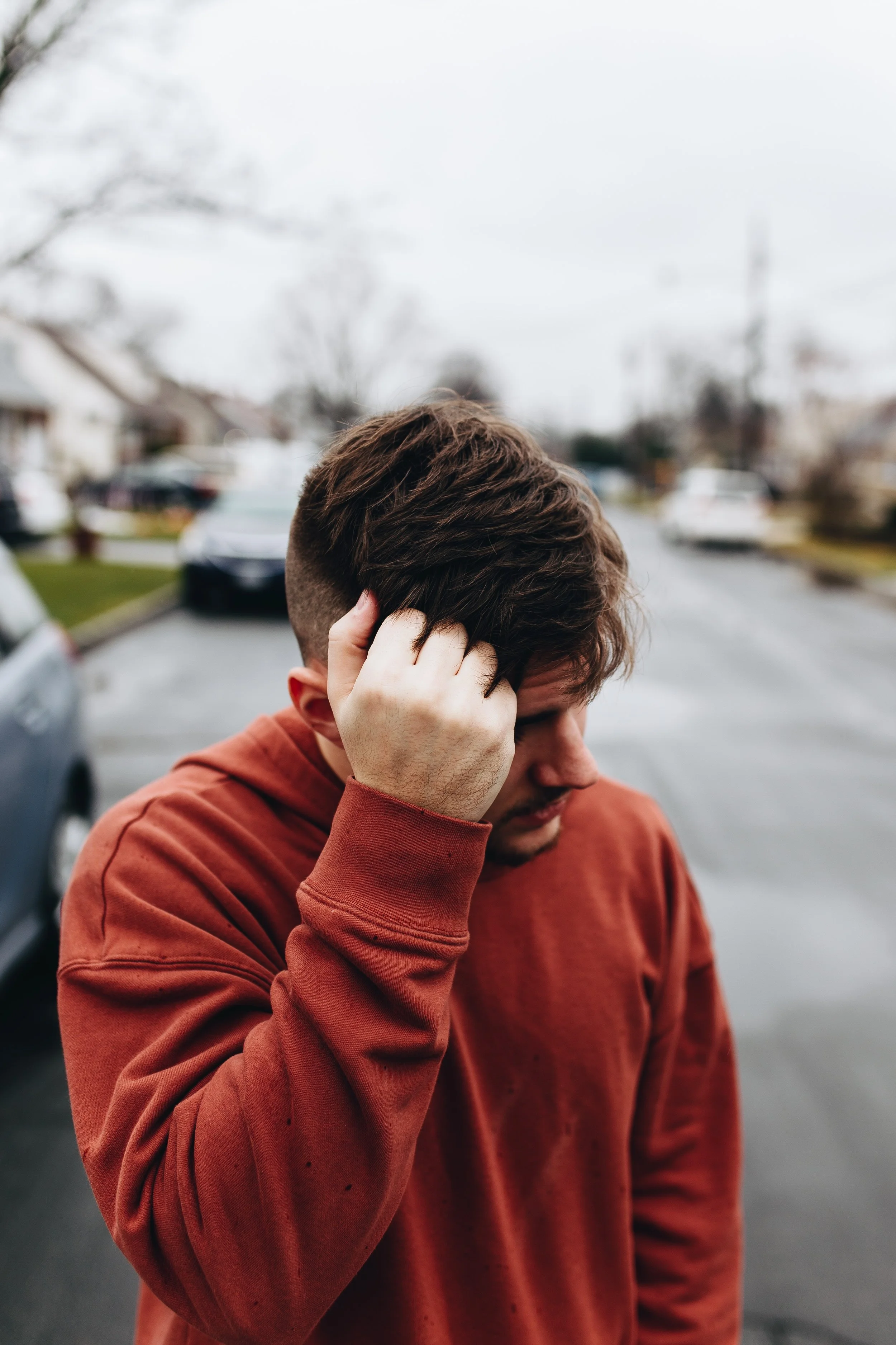 anxious man pulling at his hair with right hand