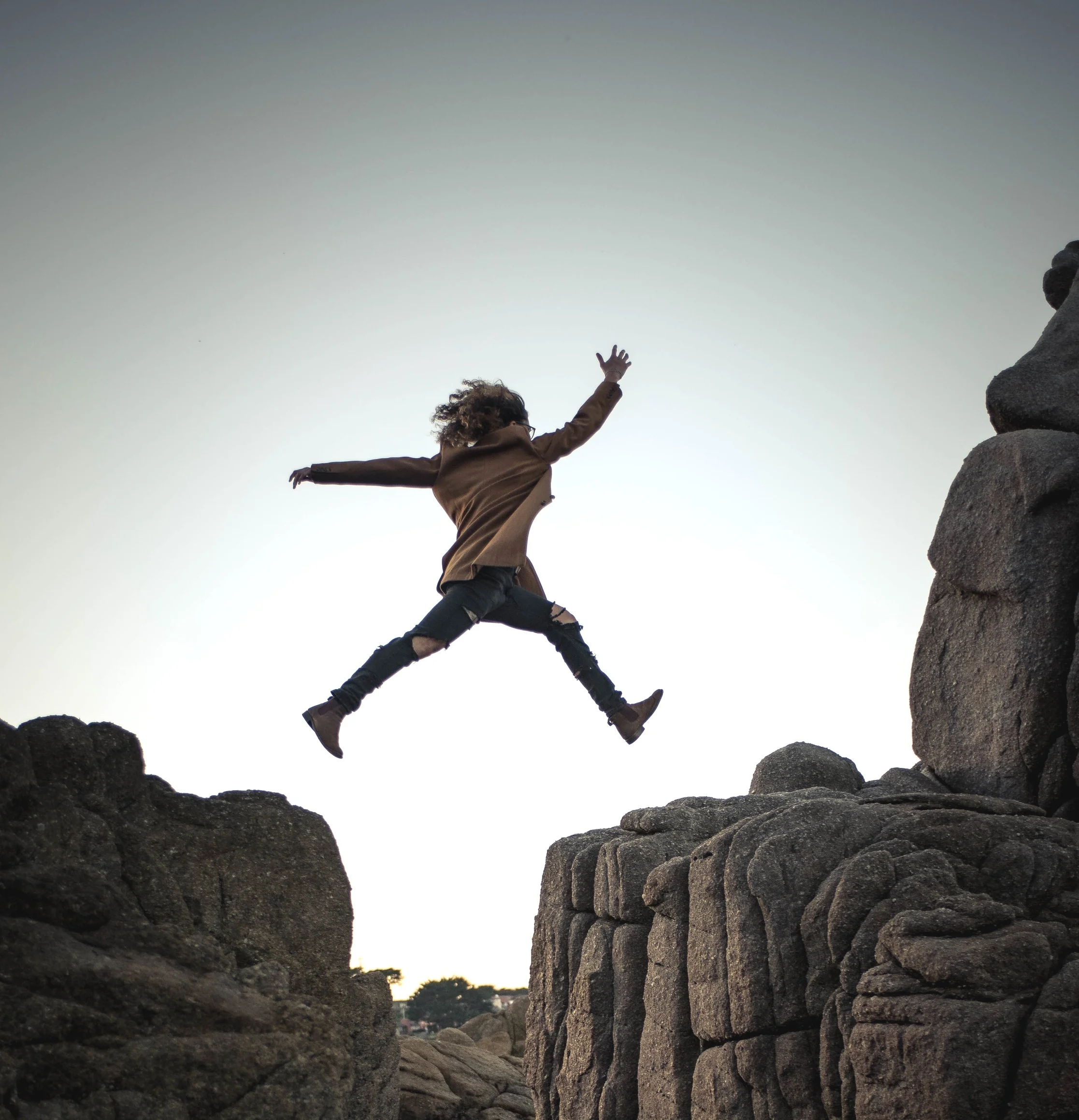 woman jumping to conquer her fear