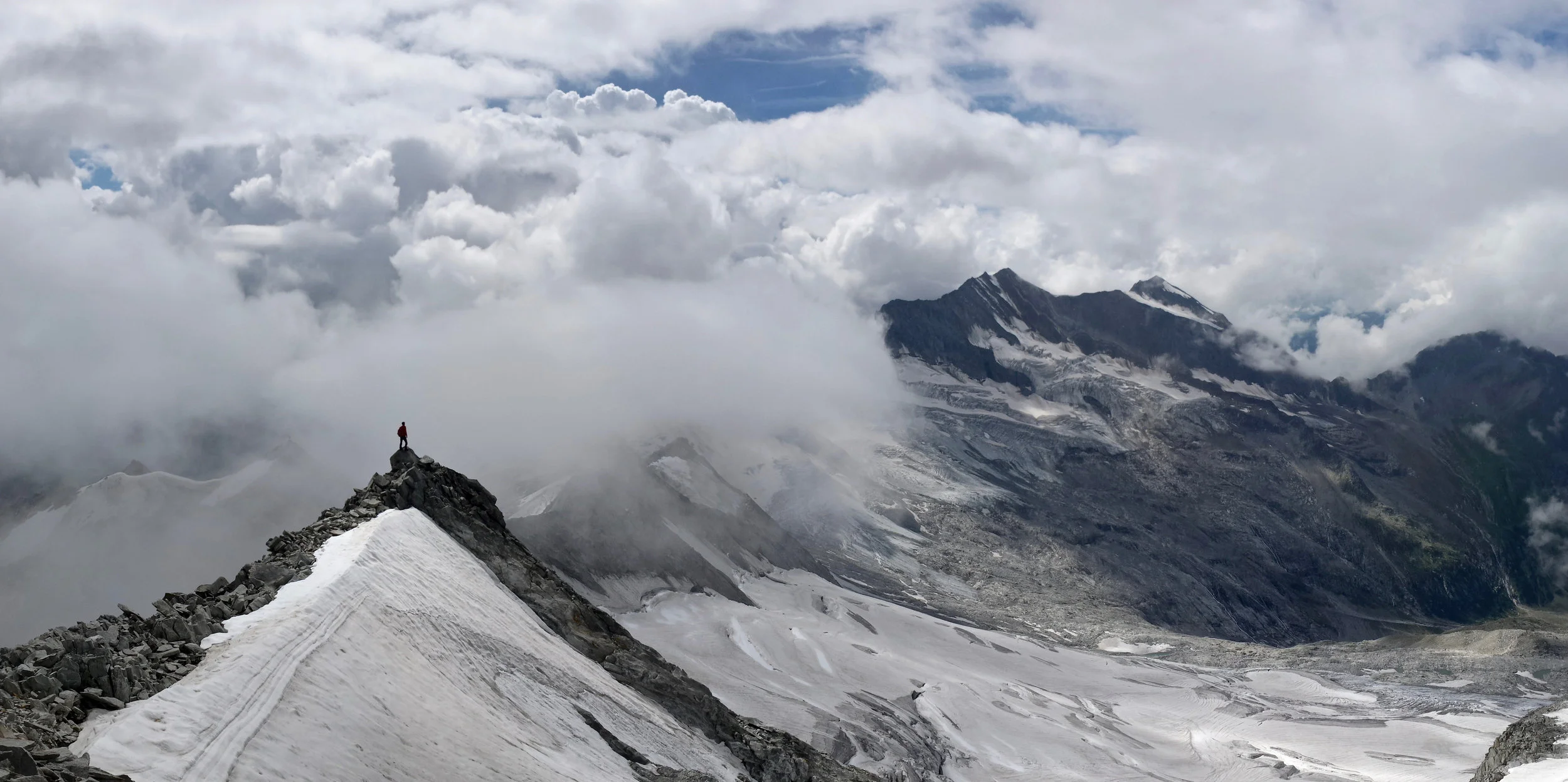 man standing on top of mountain looking for purpose