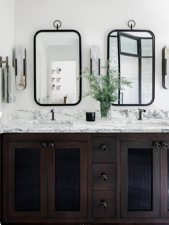 A classic black-and-white palette, elevated with modern materials and decorative details. 🖤🤍

Interior Design: @studio_wellington
Photo: @laurenchambers_interiors
Cabinetry: @morgancreekcabinetco 

#blackandwhitebath #bath #bathroomremodel #bathroo