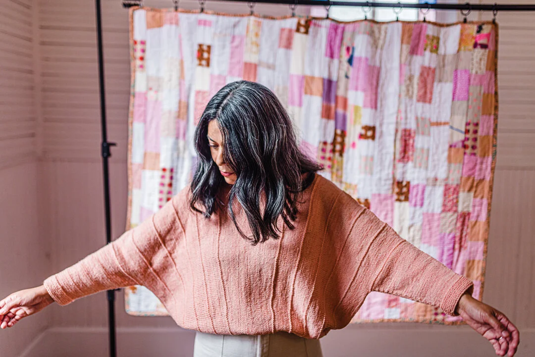 Sarah’s height is 160cm / 5’ 3” with a chest (fullest point) circumference of 81cm / 32”, and is shown wearing the long, single colour version in a size 2