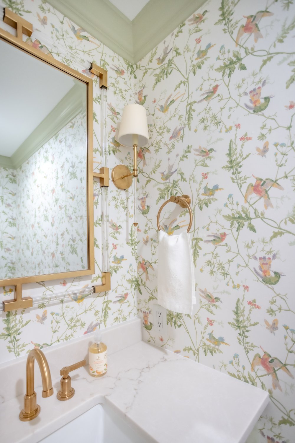  green and gold powder room design with wallpaer 