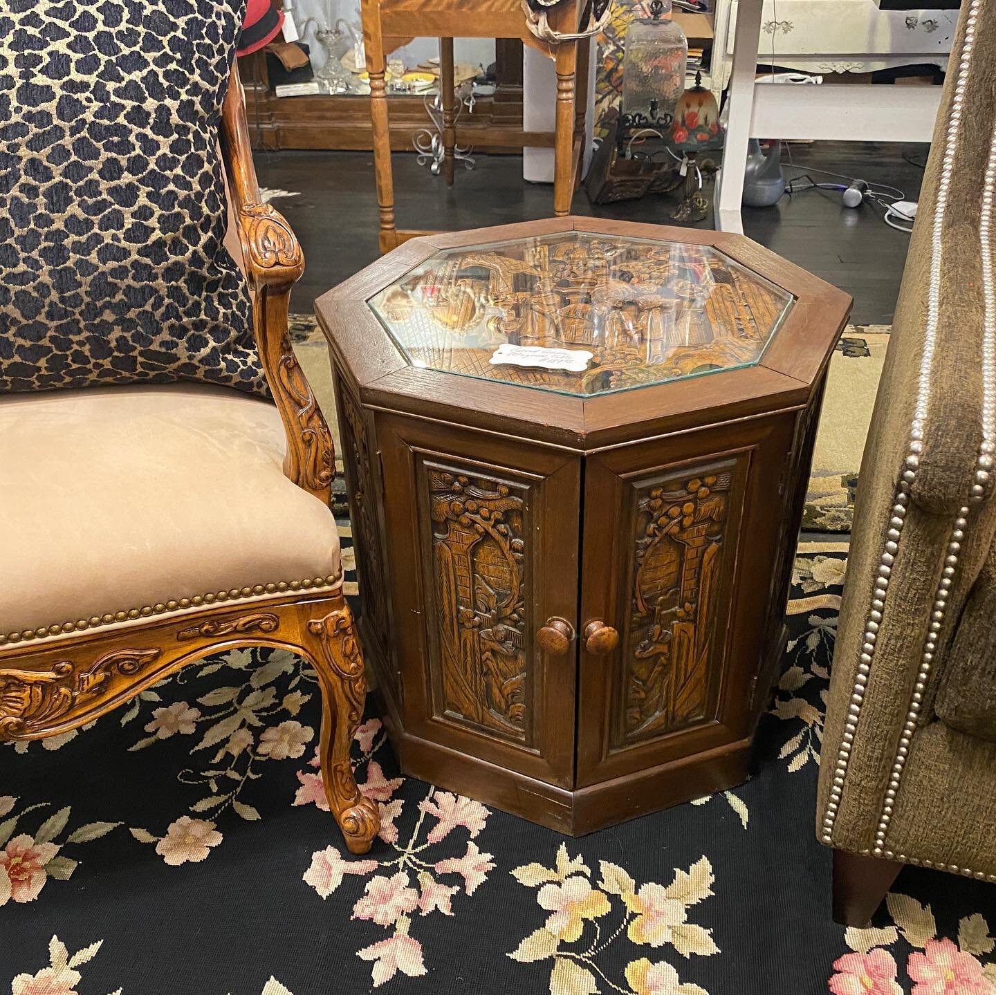 Beautifully Carved Asian Side Table. The top carvings are protected by glass. There is also plenty of storage space inside.