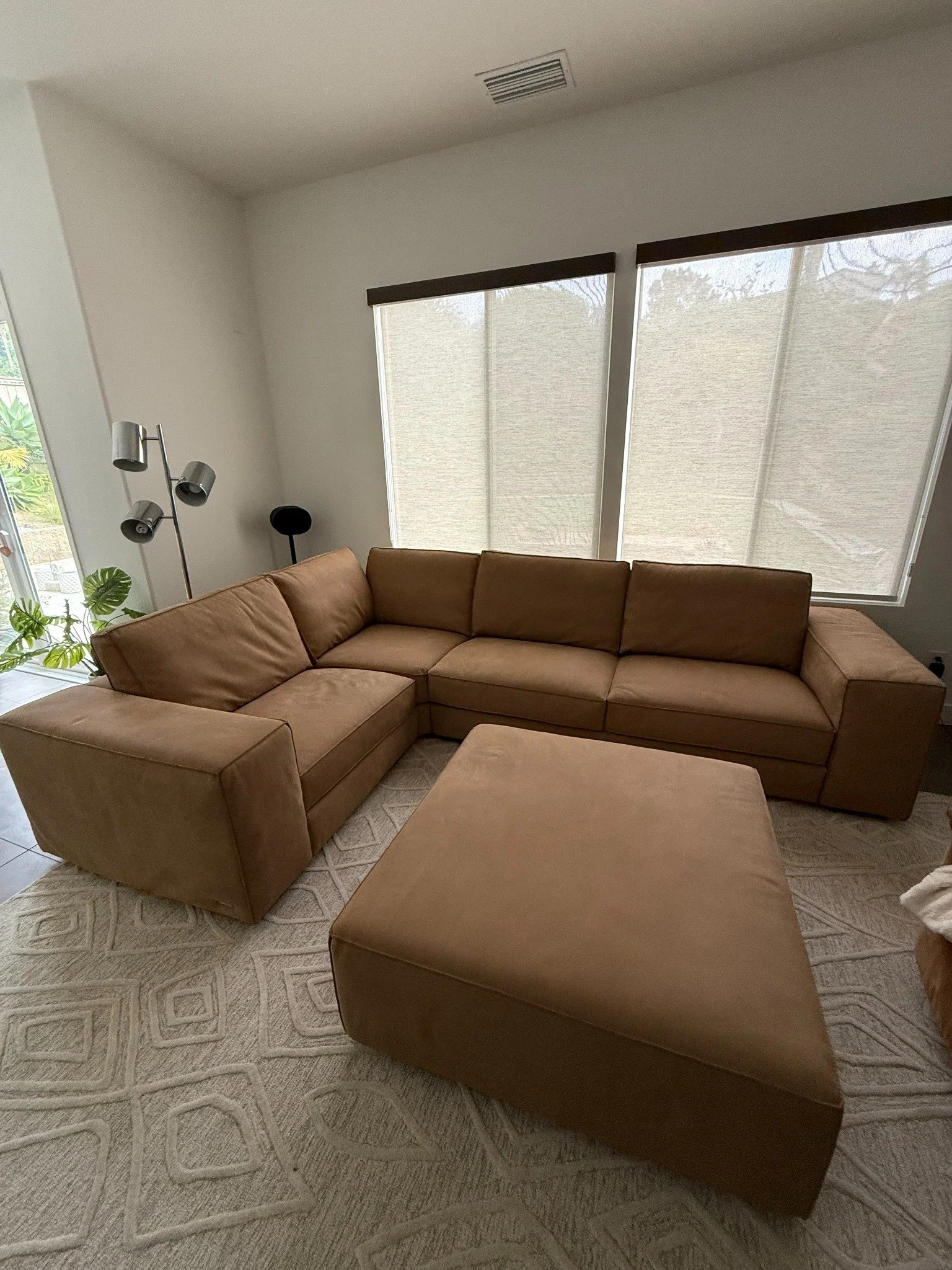 Cleaned brown leather sectional with matching ottoman