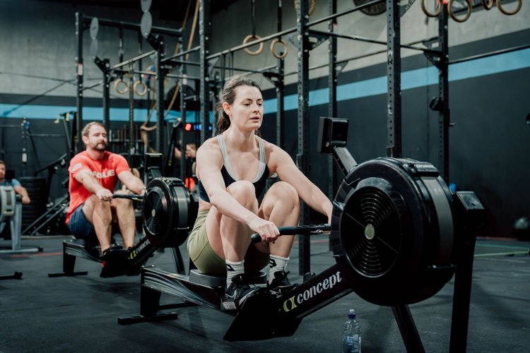 Members rowing side by side on Concept2 rowers during a CrossFit group class in Balmain