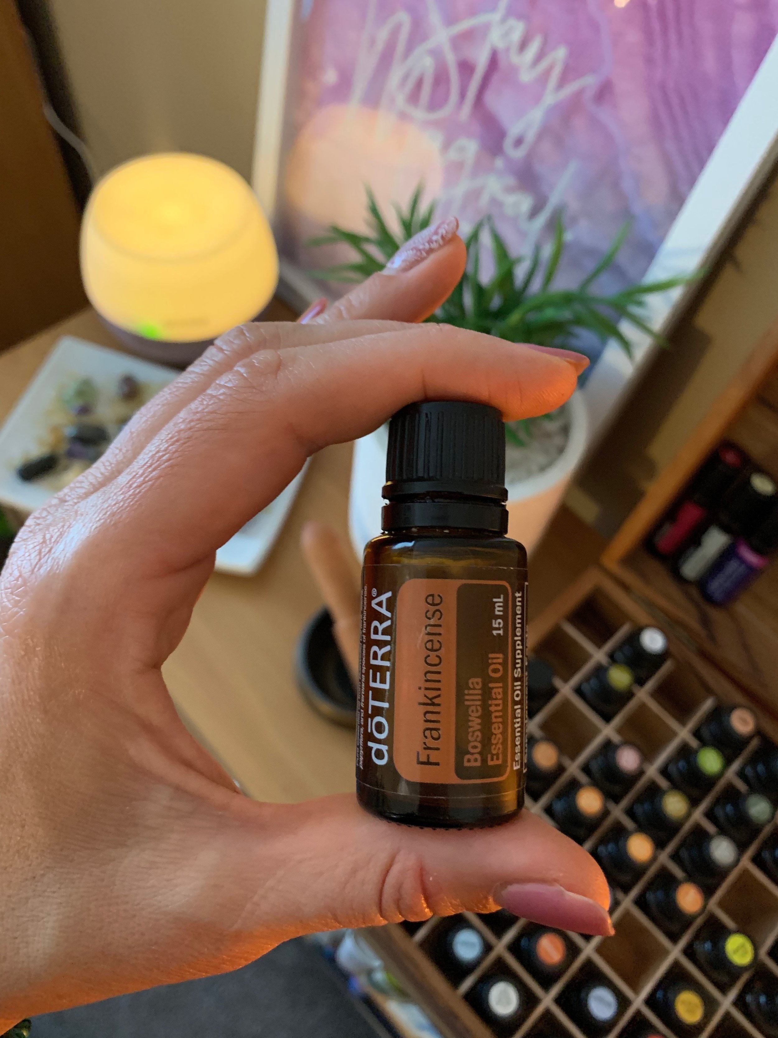 frankincense holding the bottle .JPG