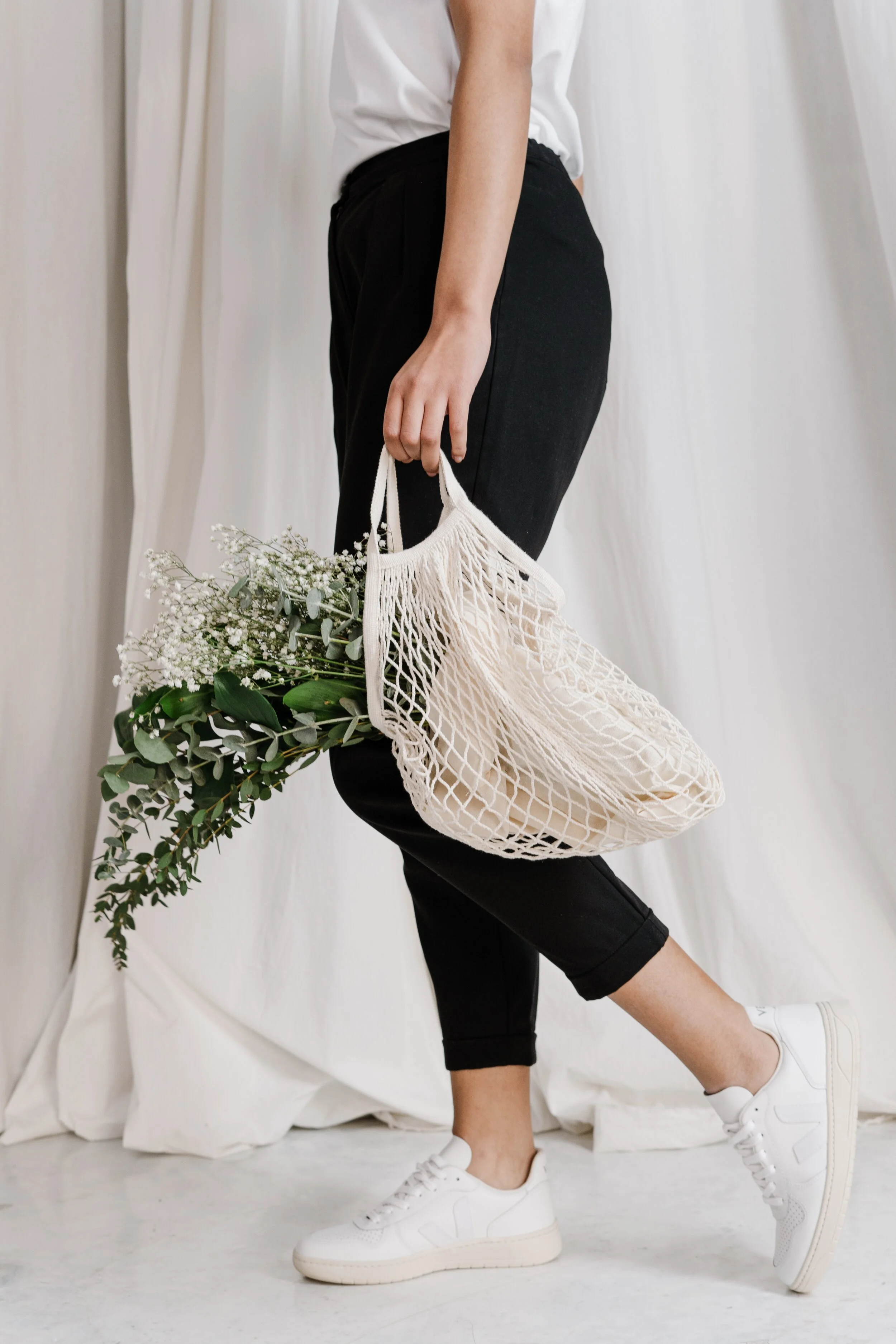 woman-in-black-pants-holding-net-bag-3738029.jpg