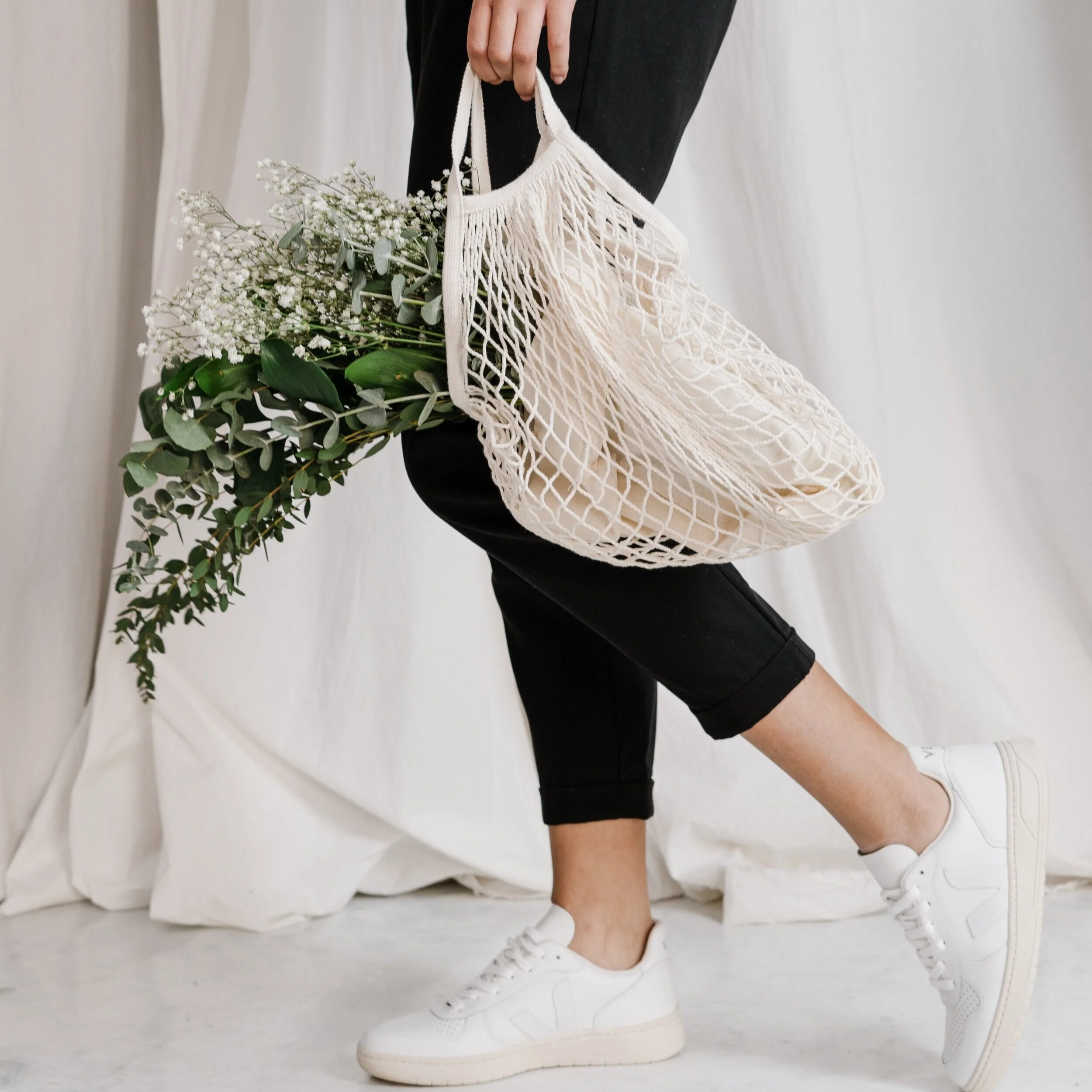 woman-in-black-pants-holding-net-bag-3738029.jpg