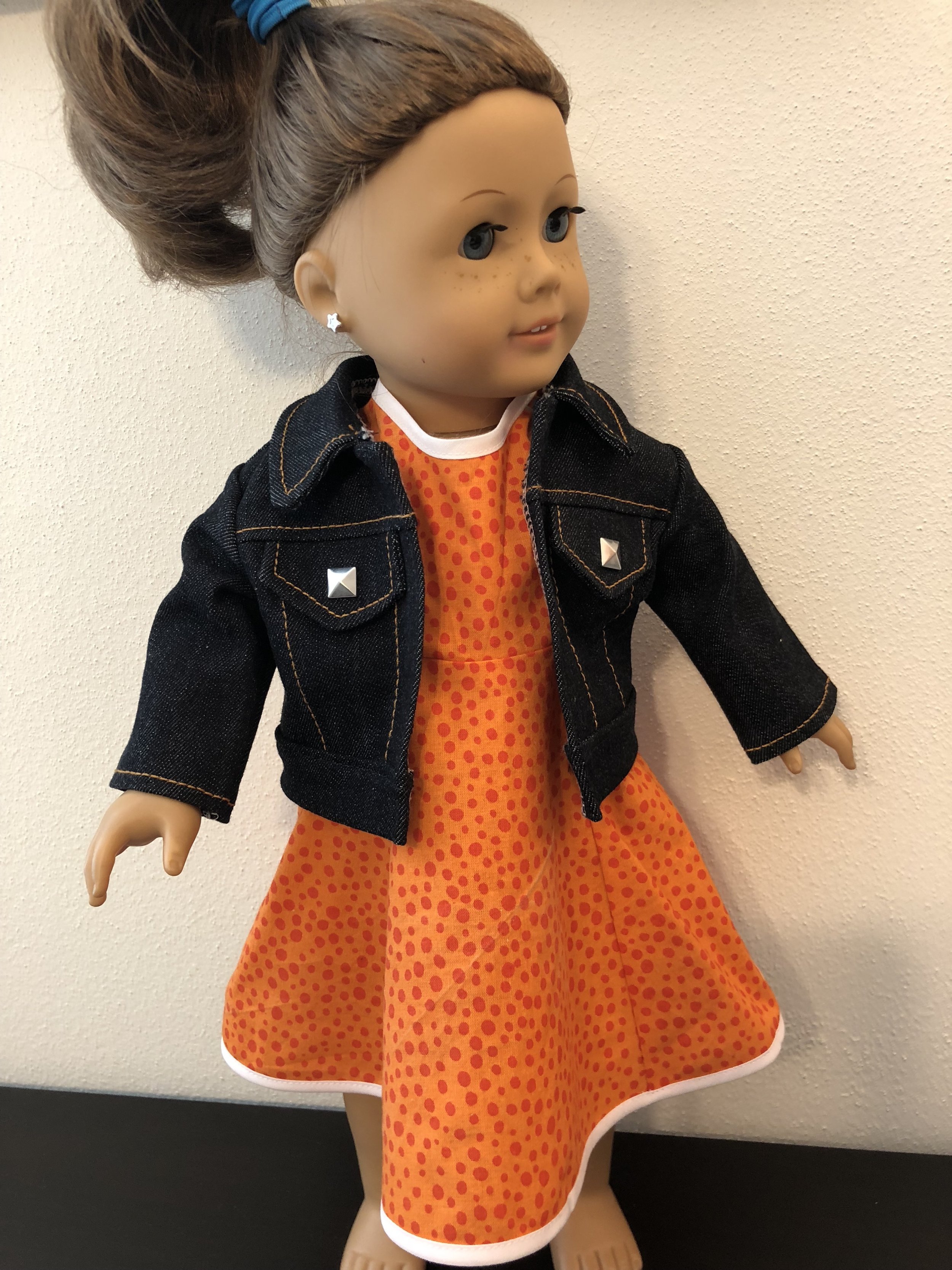  Dark wash denim jacket with studs and orange shift dress 