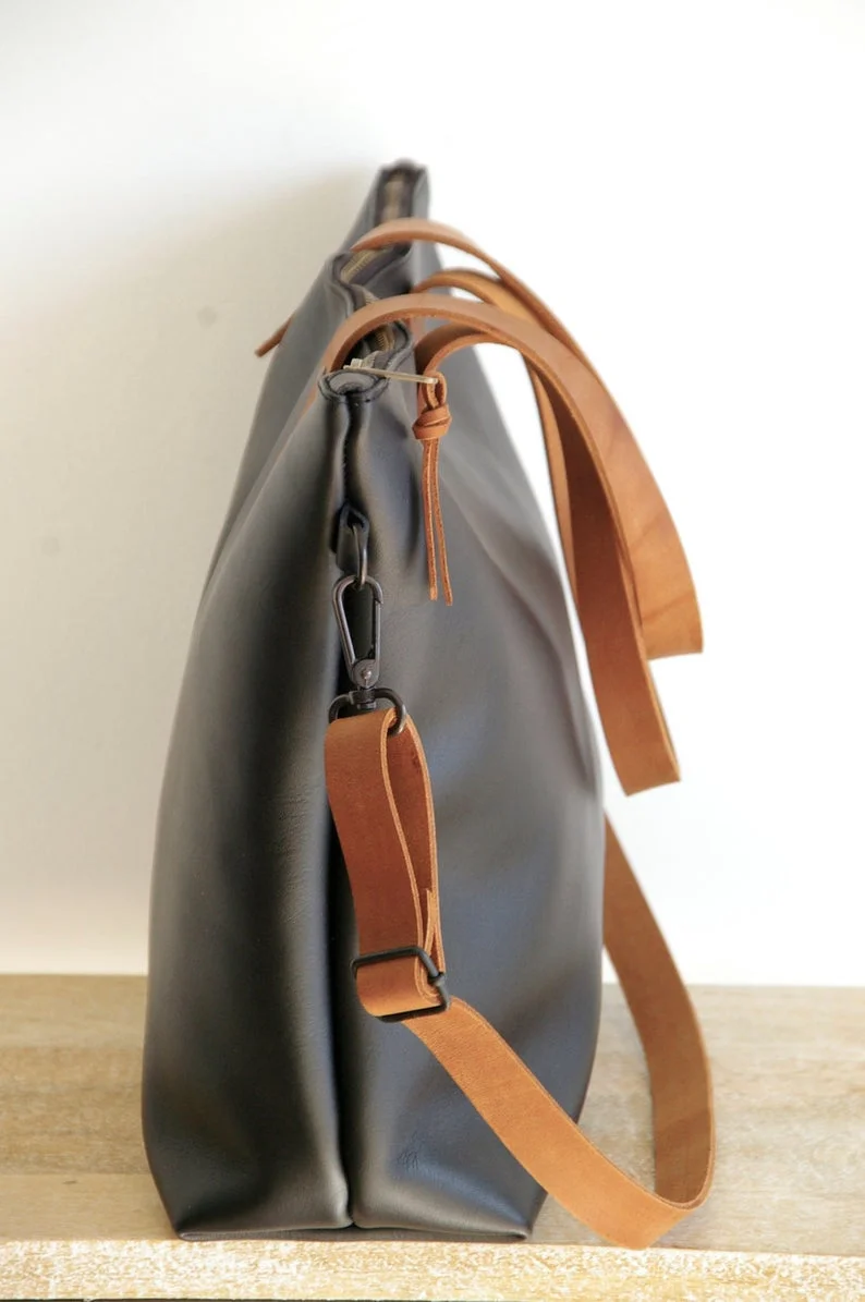 black backpack with brown straps