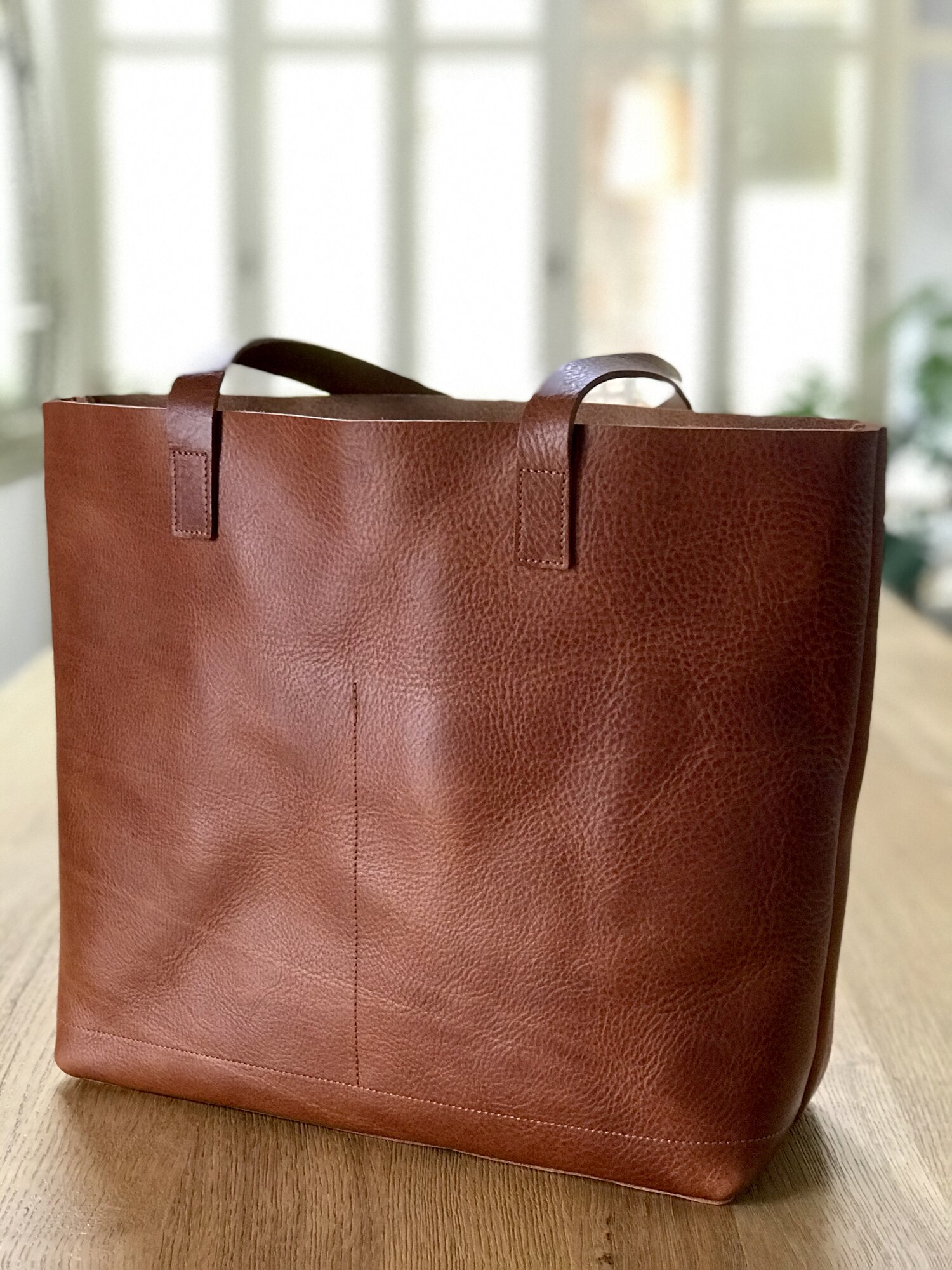 Tan / Cognac Leather tote bag with large outside pocket. The