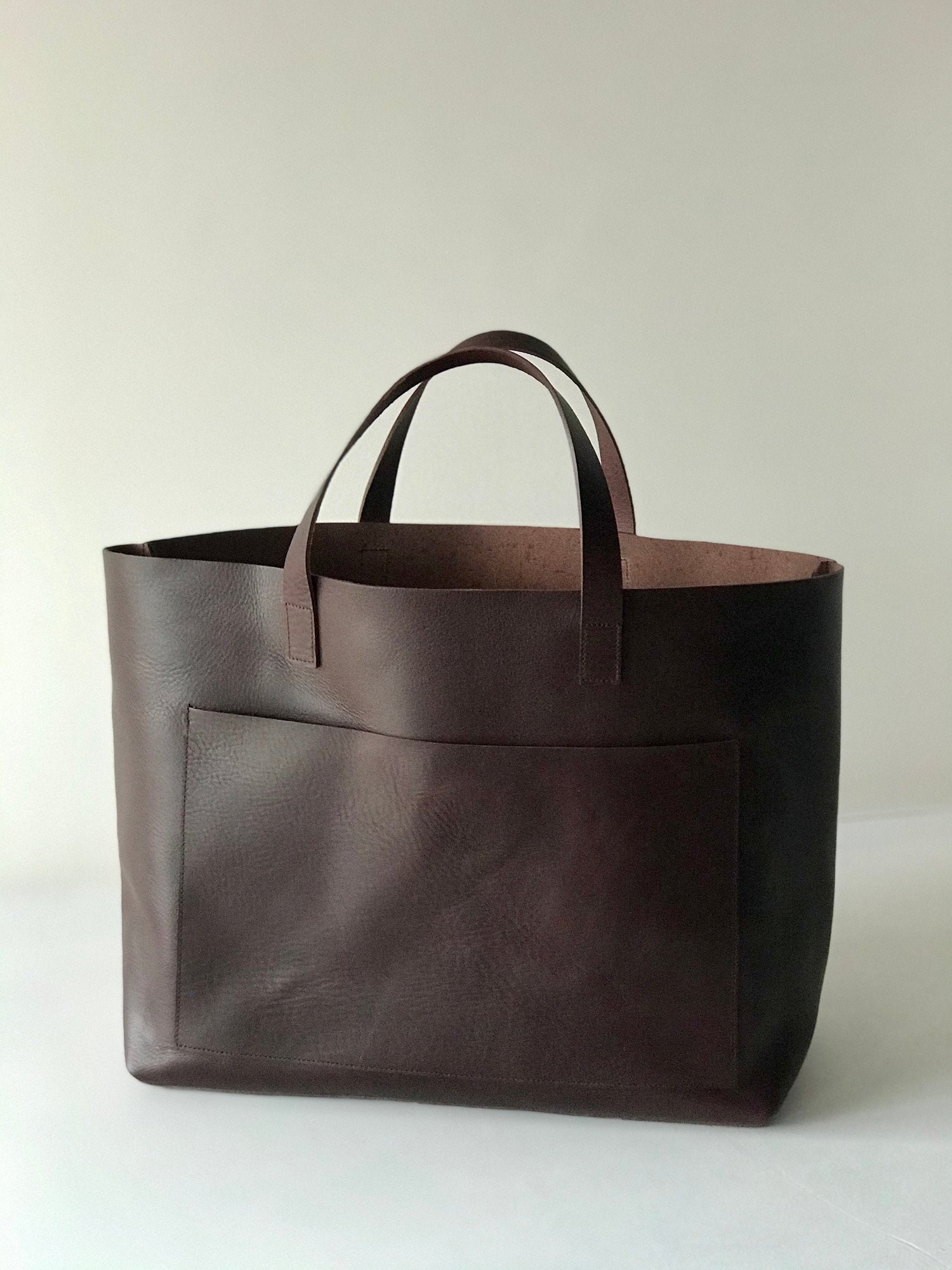 Black Leather tote bag with large outside pocket. Cap Sa Sal Bag