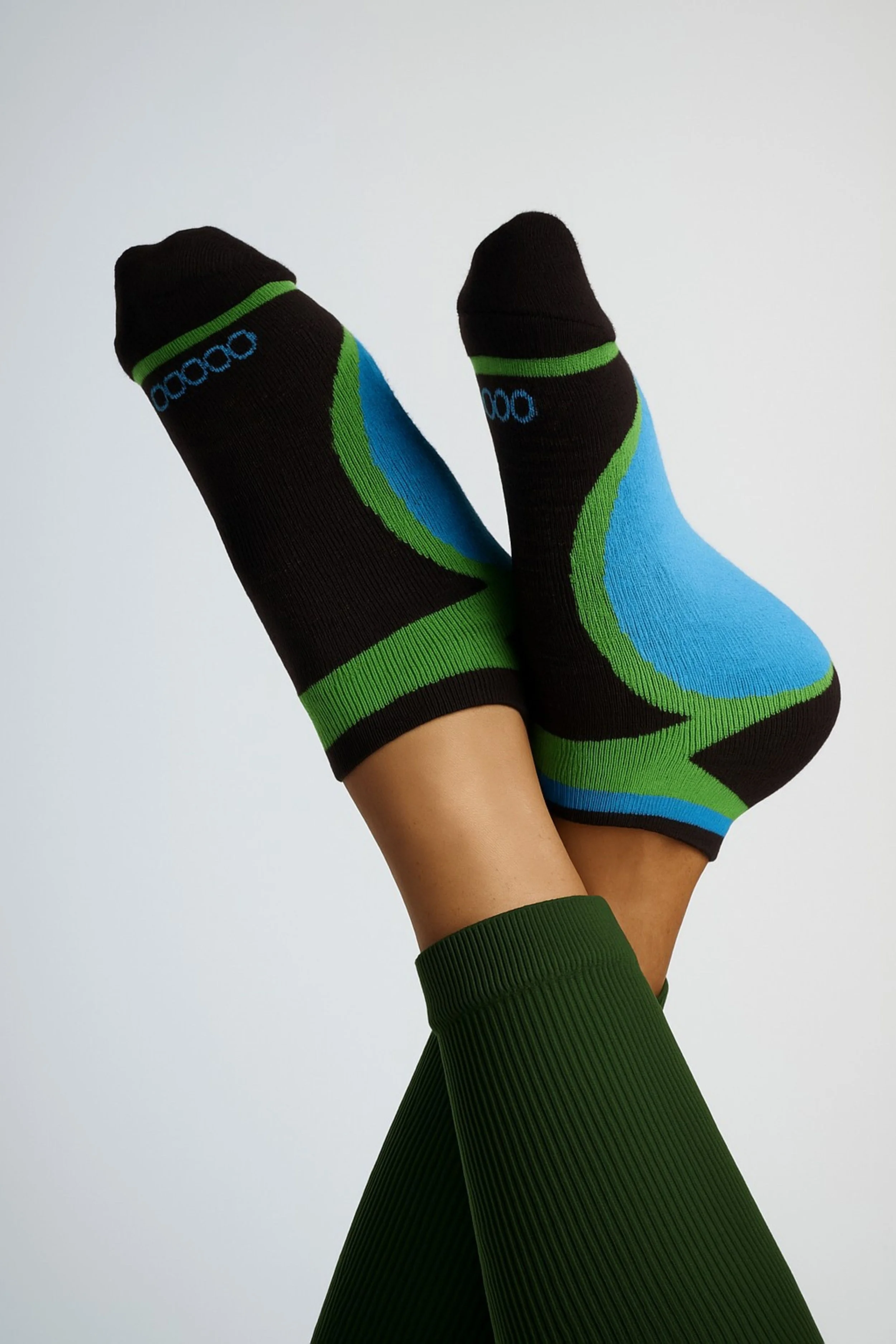 Women wearing multicolor low-cut performance running socks in black, blue, and green with a breathable, cushioned fit for running and everyday comfort.