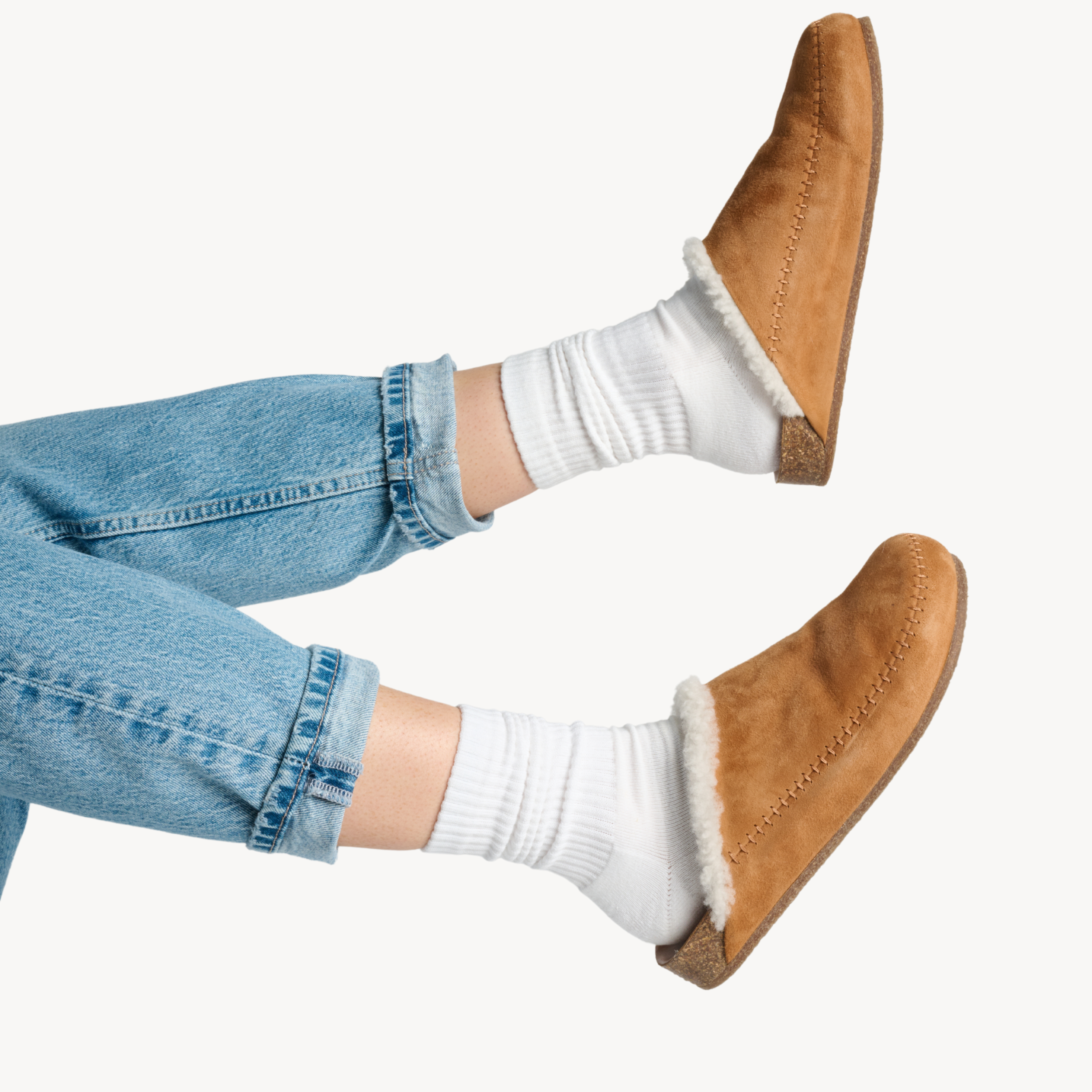 Woman wearing white crew-length performance socks with casual shearling slip-on shoes and denim, everyday comfort and cushioned support by Agogo Active.