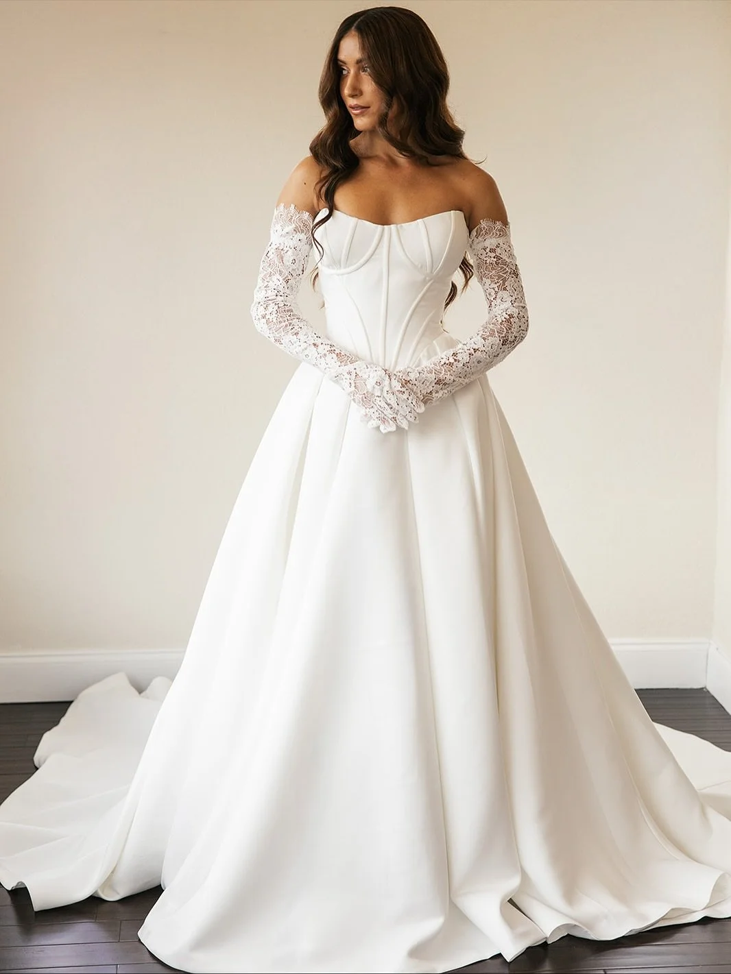 From our 2026 Collection, a study in modern simplicity.
A structured bodice and full Mikado skirt meet delicate lace details, creating a look that&rsquo;s effortlessly refined and distinctly ours.