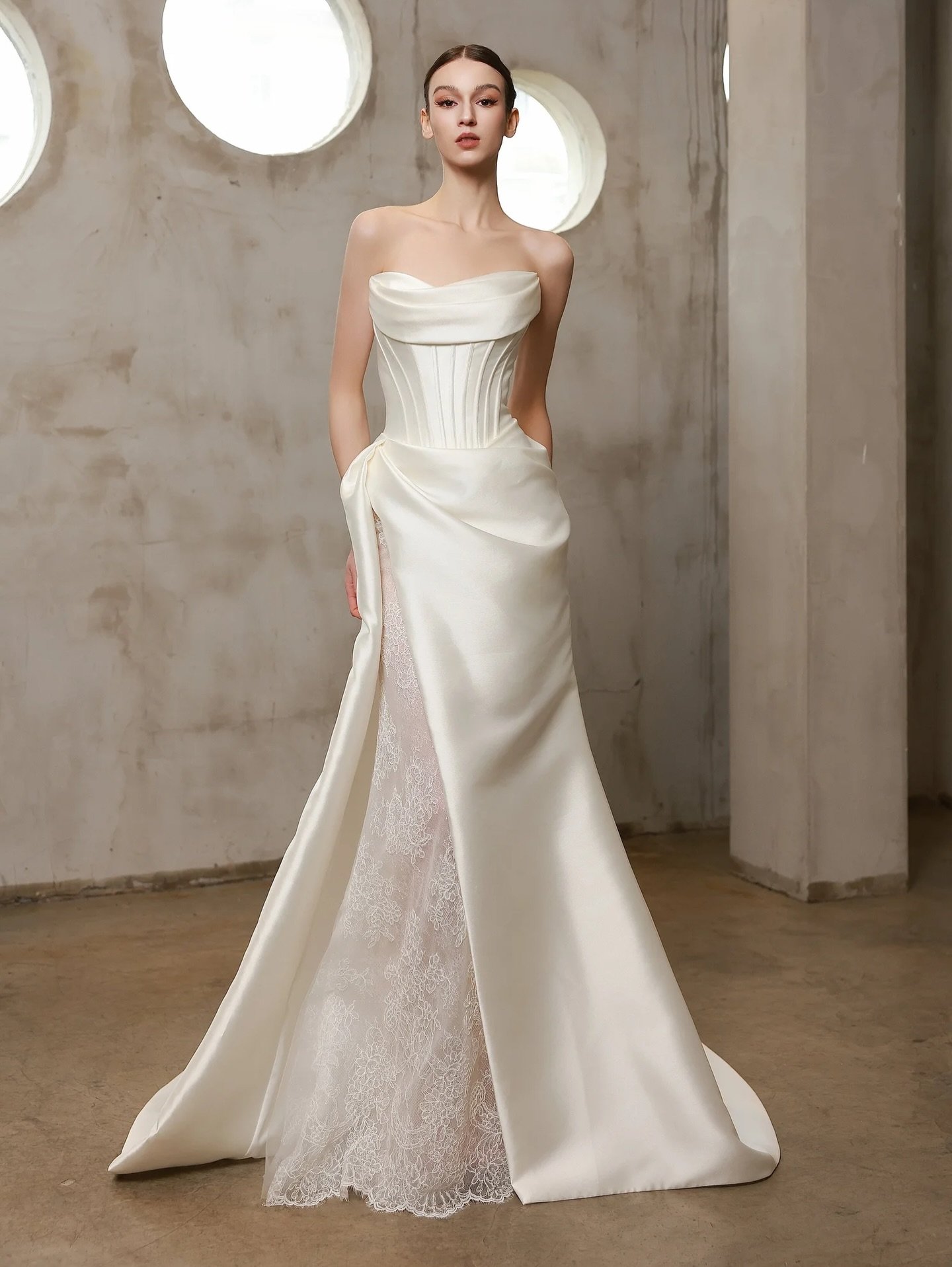 A store favorite for a reason 🤍

This strapless satin gown is modern elegance done right. A softly draped neckline, sculpted bodice, and a refined A-line skirt that opens to the prettiest lace inset. Clean, romantic, and just unexpected enough.
If y