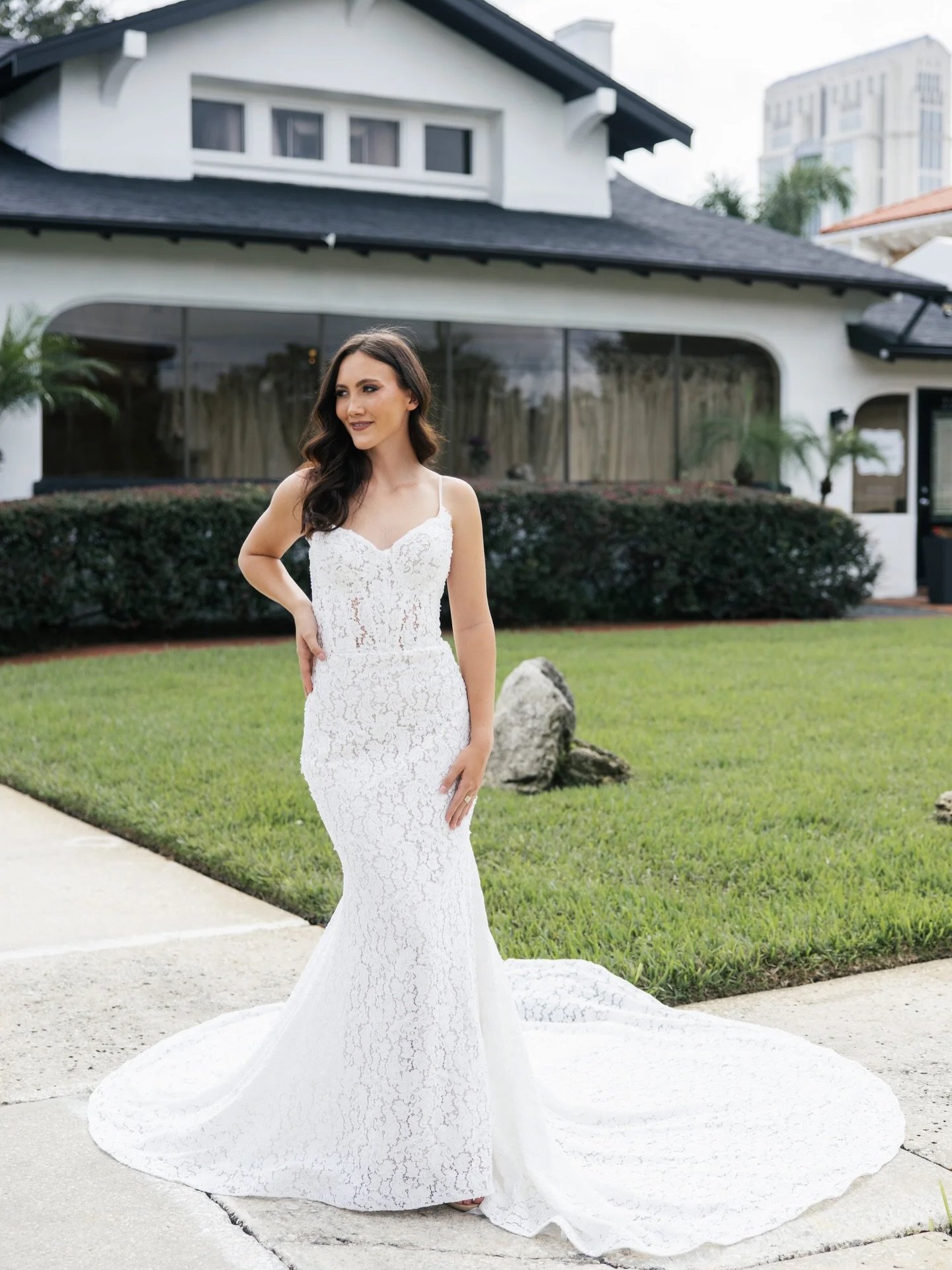 This fitted lace gown offers an elegant take on modern simplicity. The silhouette hugs the figure in a soft, flattering stretch lace that adds texture without overwhelming the design. #bgsbride