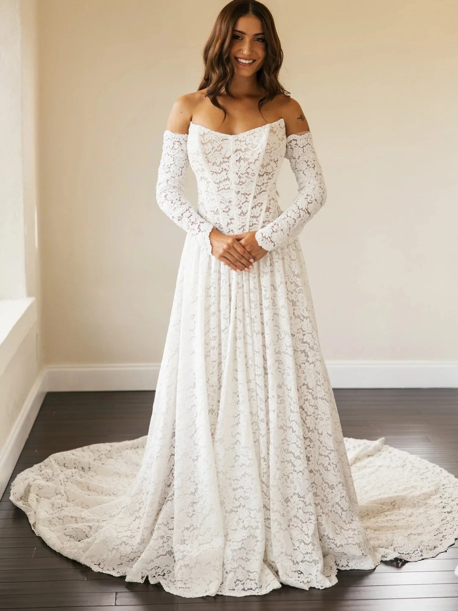 An exclusive from our own collection. HA3211 is a romantic lace masterpiece designed for the bride who loves timeless texture with a modern twist. Crafted entirely from soft, allover lace, this gown features a sculpted corset bodice with a cat-eye ne