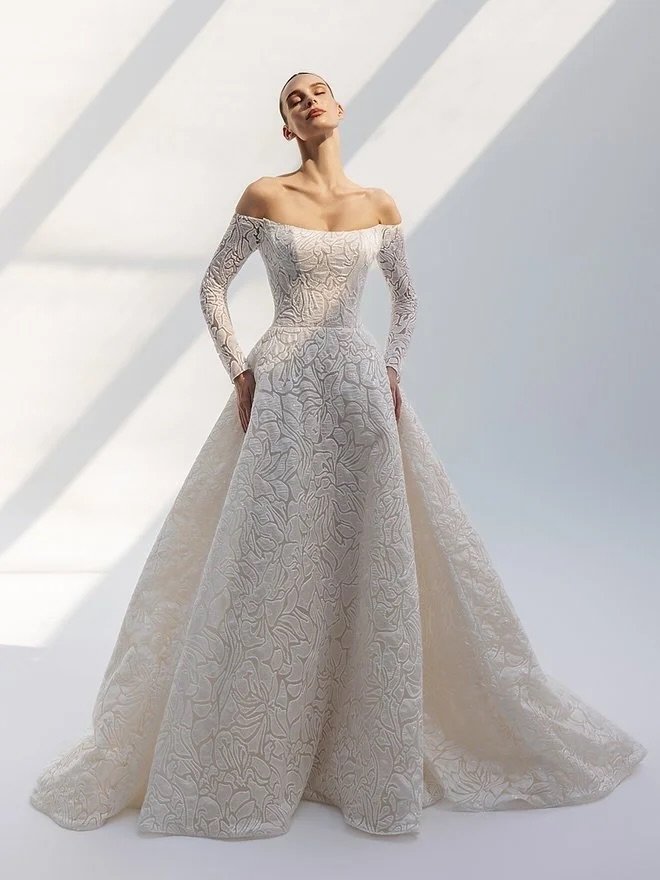 Quiet texture, sculpted lines, and timeless elegance. A jacquard A-line made for the bride who knows restraint can make the strongest statement. 🤍