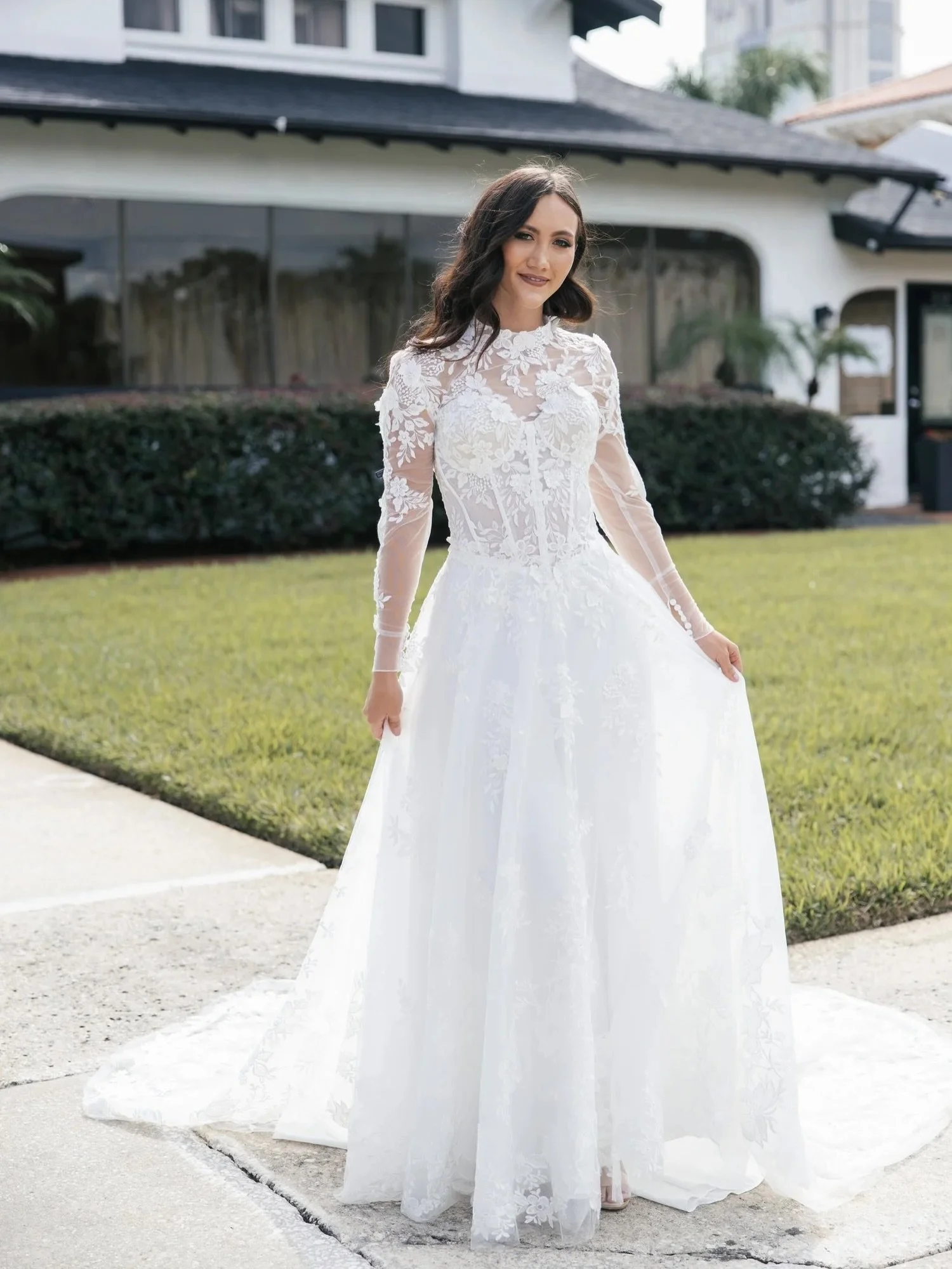 Vintage romance, reimagined. HA3138 from our studio-exclusive collection pairs delicate floral lace, sheer sleeves, and a high illusion neckline with a beautifully structured corset and effortless A-line silhouette.