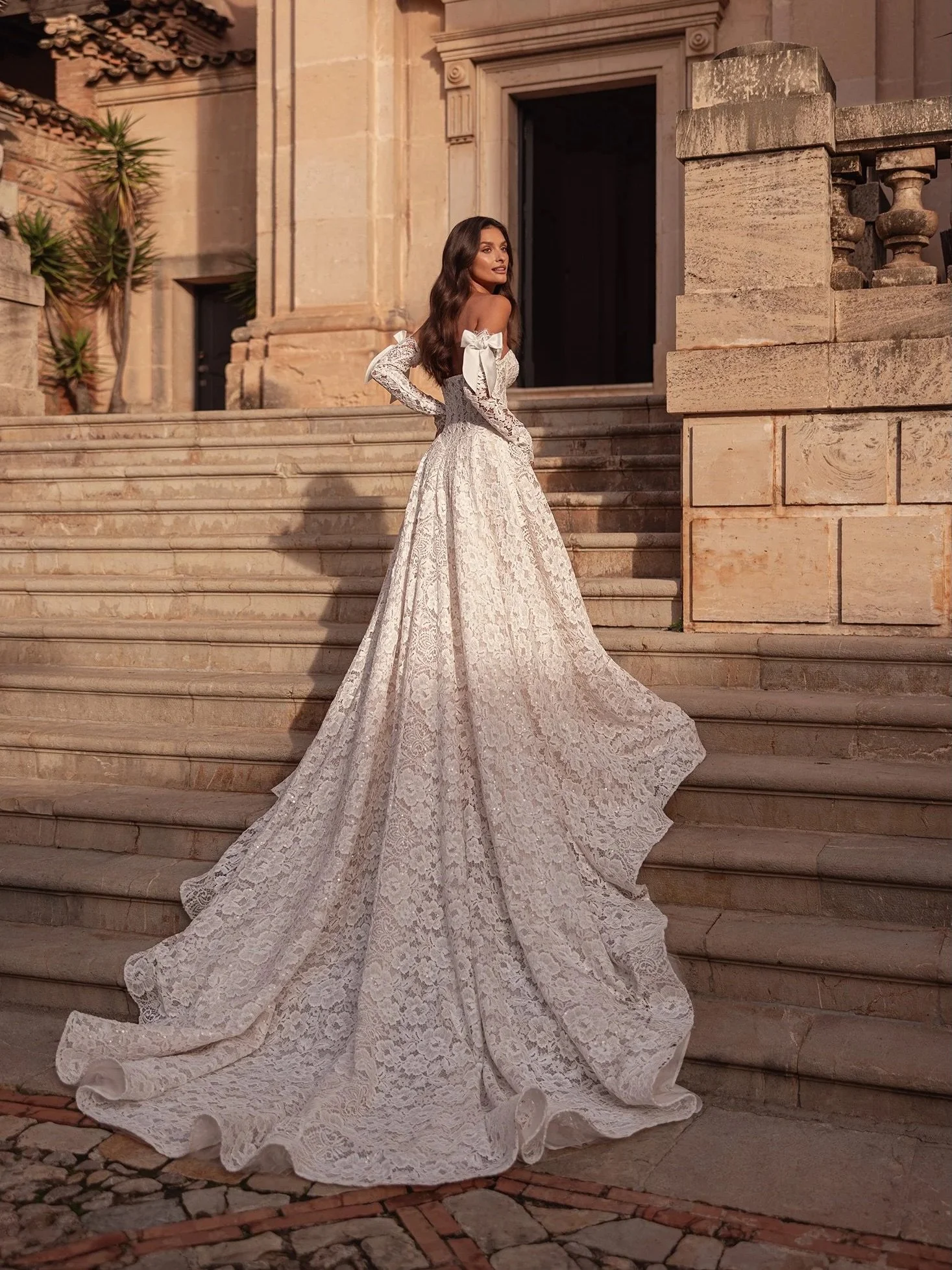 Meet Brooklyn 🤍 Allover sequinned floral lace, a sculpted corset bodice, and detachable lace sleeves finished with the sweetest bow details. Romantic from every angle.