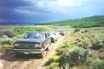 10. Made August 23, 1997 near Quaking Aspen Ridge, WY, SW of Ft. Bridger, WY. Caravan Near Quaking. Photograph by Steve Berlin. The field trip caravan consisted of about 15 four-wheel-drive vehicles, most carrying several members. Here we are seen on Quaking Aspen Ridge near the place where the trail veers off the ridge, climbs a little more and starts a steep descent. A sprinkle of rain has made the road slick. The view from the high ridge is beautiful and vast in all directions. This route was used by, among others, Brigham Young. "About 3 o'clock we resumed our journey starting up the valley; we passed over a small hill, and then ascended the dividing ridge by a zigzag road. A she bear and two cubs were seen by Brother Cloward going (up) a high hill on our left hand. We descended by two steep pitches, almost perpendicular, which on looking back from the bottom looks like jumping off the roof of a house to the middle story and then from the middle story to the ground. Thank God no accident happened." (They had locked their wheels for over 1/2 mile) - Thomas Bullock journal of July 10, 1847
