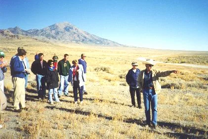 3. Made 10/18/97 at Crossroads kiosk site, ~20 miles North of Wendover, UT. A lso Hastings Road. Photograph by Steve Berlin. View looking north, Pilot Peak in the background. Al Mulder, at the site of the coming Utah Crossroads Chapter interpretive kiosk, points to important trail landmarks including nearby Bidwell pass.