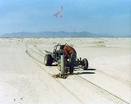 14. Made: 9/23/87 Great Salt Lake Desert, Utah. The Big Bend. Photograph: Copyright © 1961 Roy D. Tea. Dan Miller Jr. setting a 6" aluminum pipe to mark the Hastings Trail at the Big Bend. Silver Island Range in background. Compare to previous photographs in the exhibition made at this place.