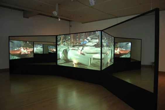 A room of mirror and displays. Soft yellows and dim lights. Private corners.