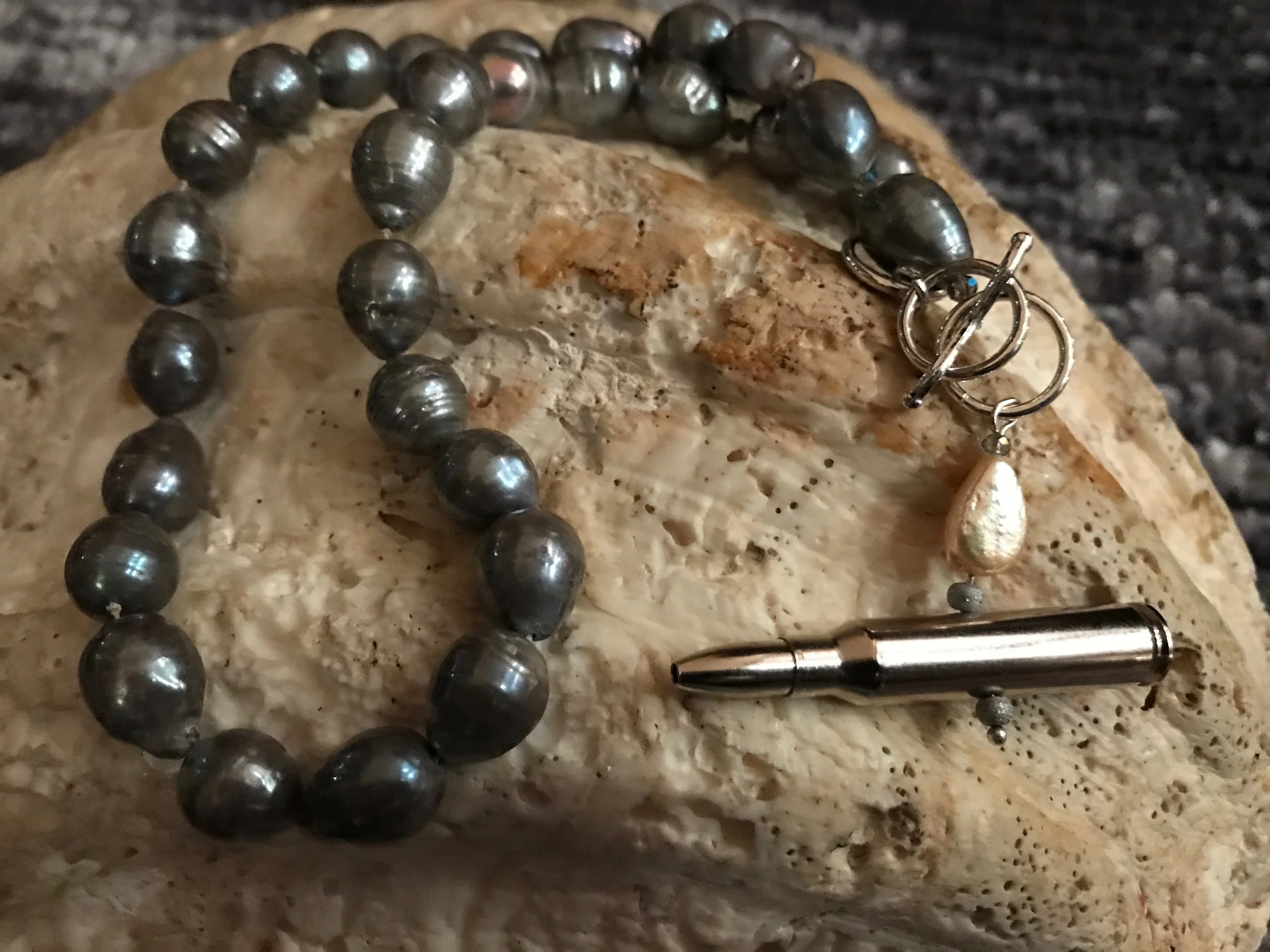 20” freshwater iridescent black pearl necklace With .223 bullet toggle