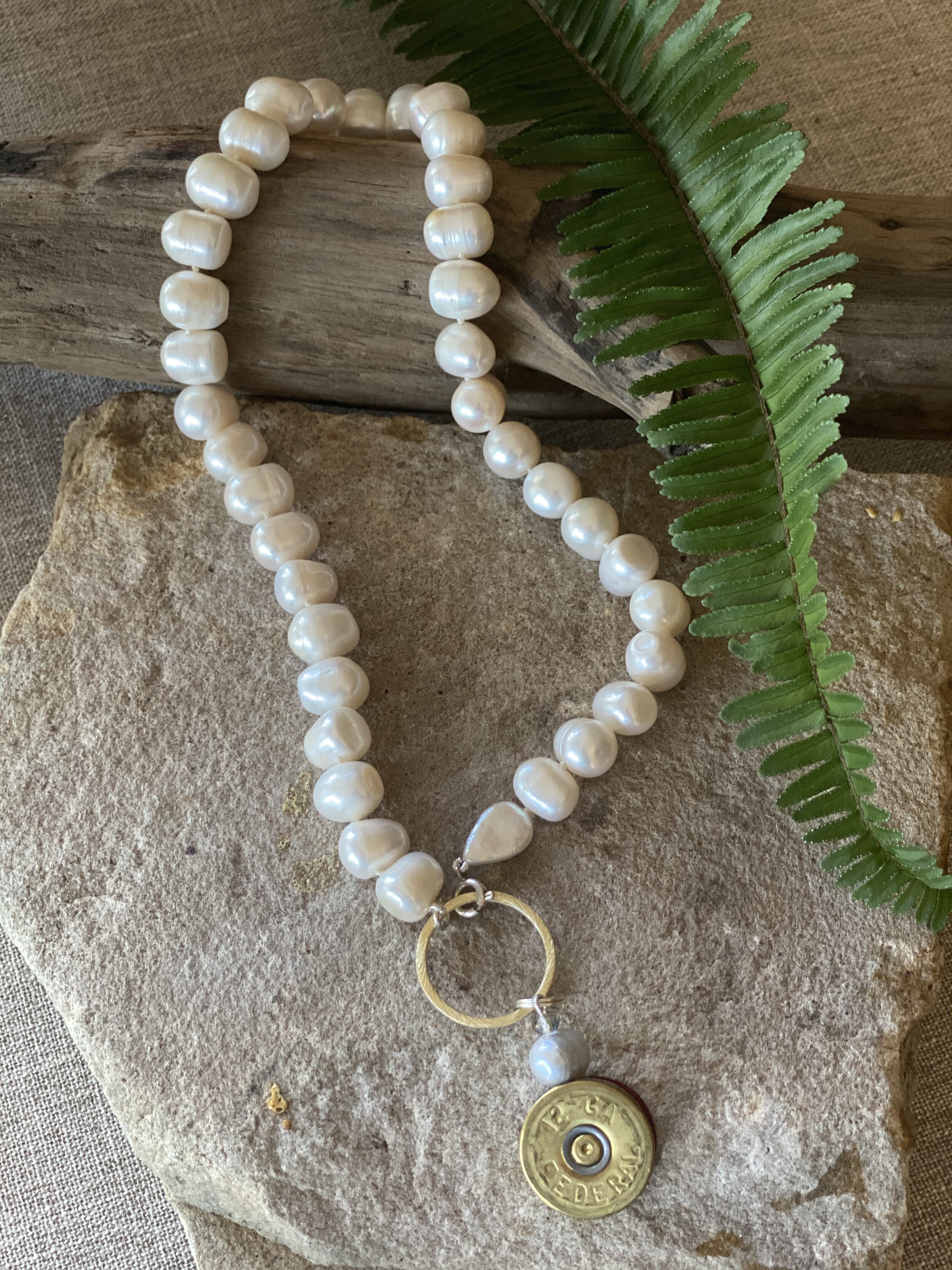 18” natural freshwater pearl necklace with brass shotgun shell pendant