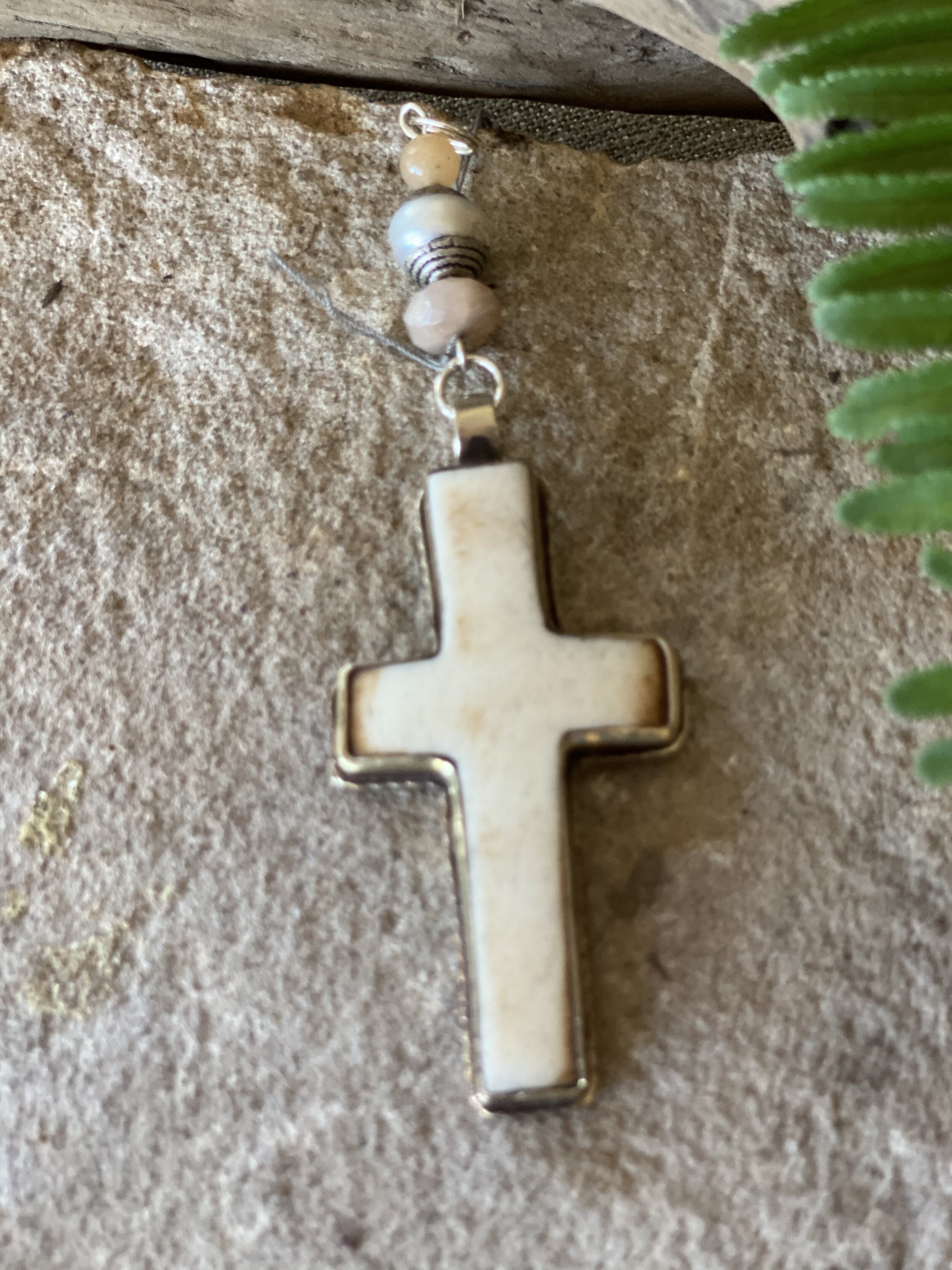 Natural cream colored bone and ornate silver cross