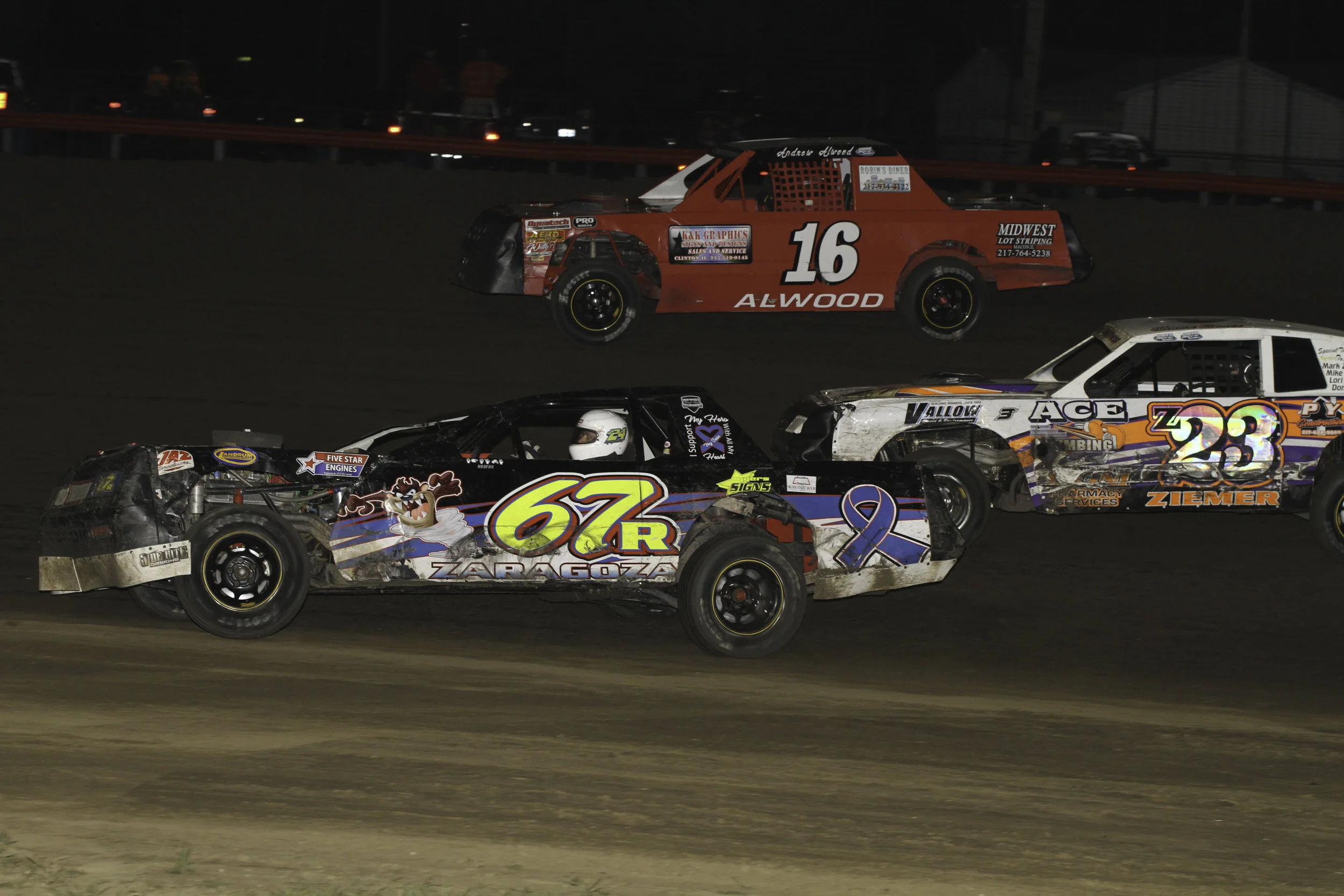 Jeremy Nichols (67R) navigates through lapped cars of Andrew Alwood (16) and Shawn Ziemer (23Z) on way to victory in the Fourth Annual What Up Dog Memorial Race. A.E. Blair Photography Photo