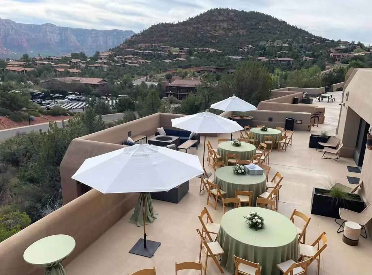 Tablescape set on an outdoor dining patio for an elegant rehearsal dinner with a refined green color palette