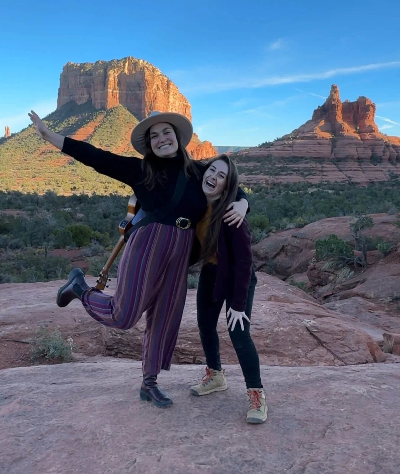 Sedona trails explored by two women enjoying the landscape and having a joyful outdoor adventure together