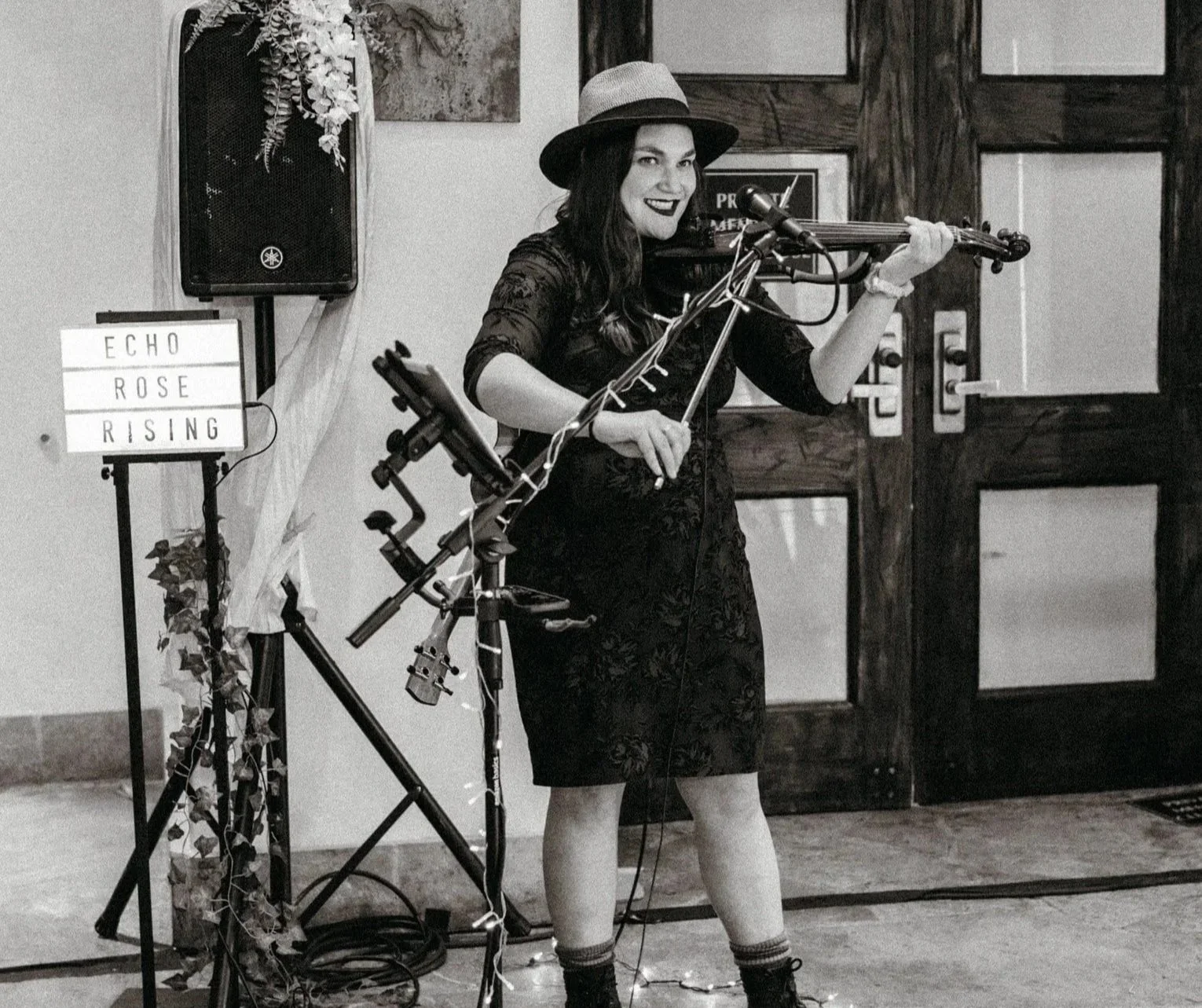 Elegant violinist providing wedding entertainment while performing at a stylish wedding venue