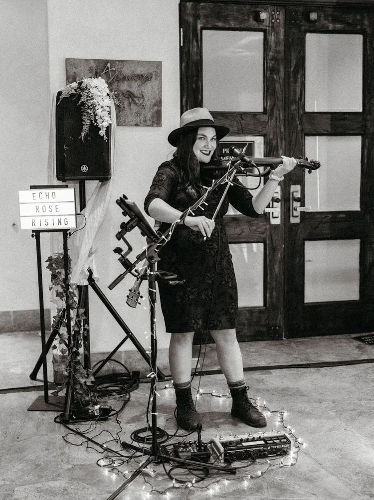 Telluride events showcased with a violinist performing during cocktail hour at an elegant ballroom wedding