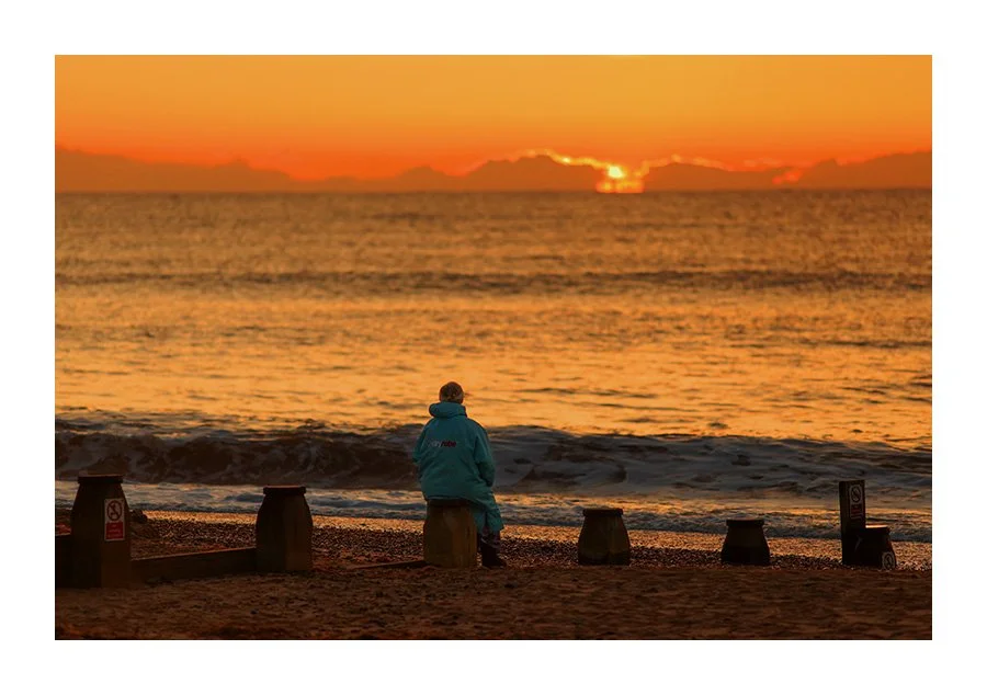 A Woman Waits For The Sunrise on Southwold Beach